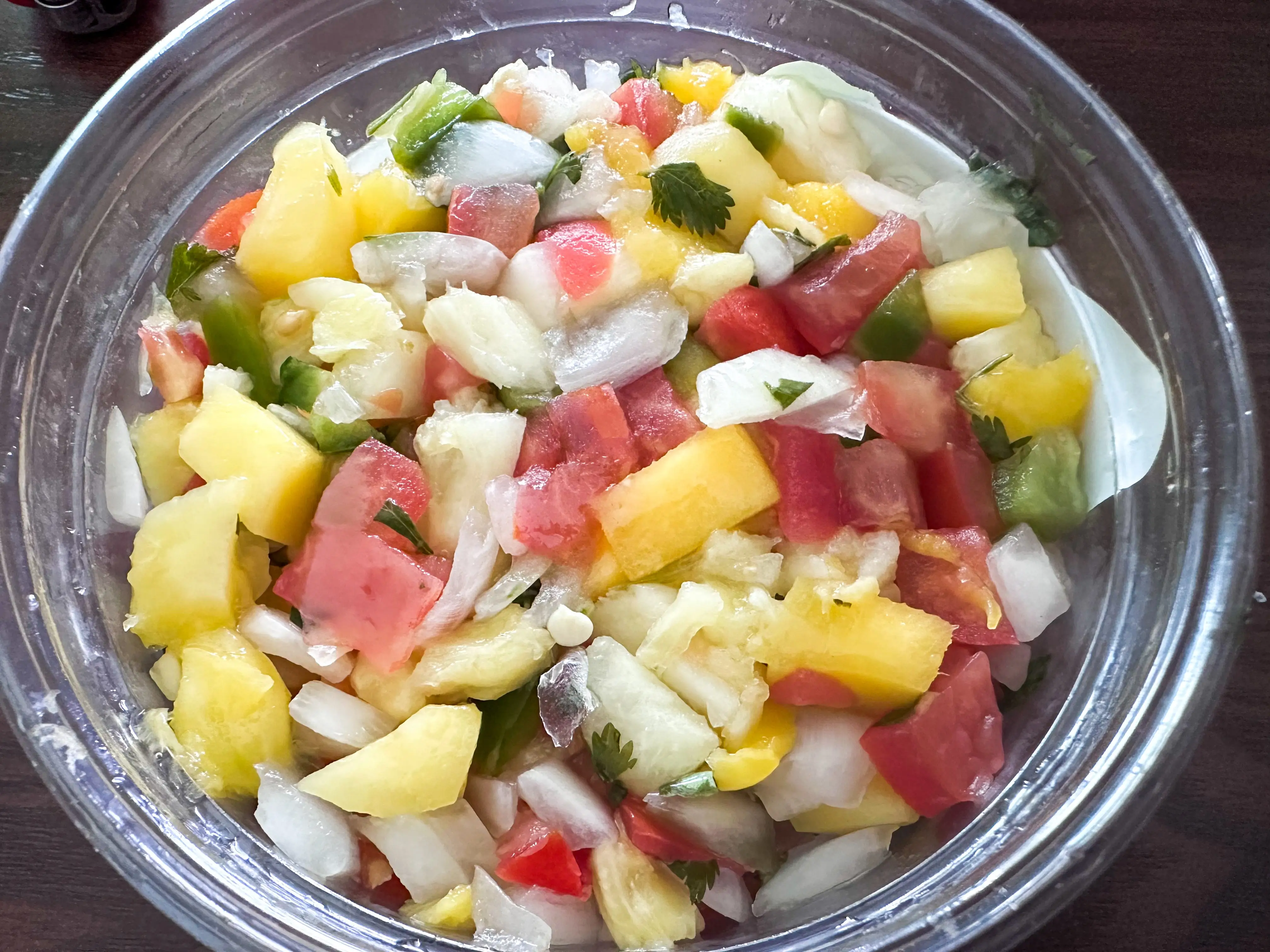 An open container of Trader Joe's mango pineapple pico de gallo salsa.