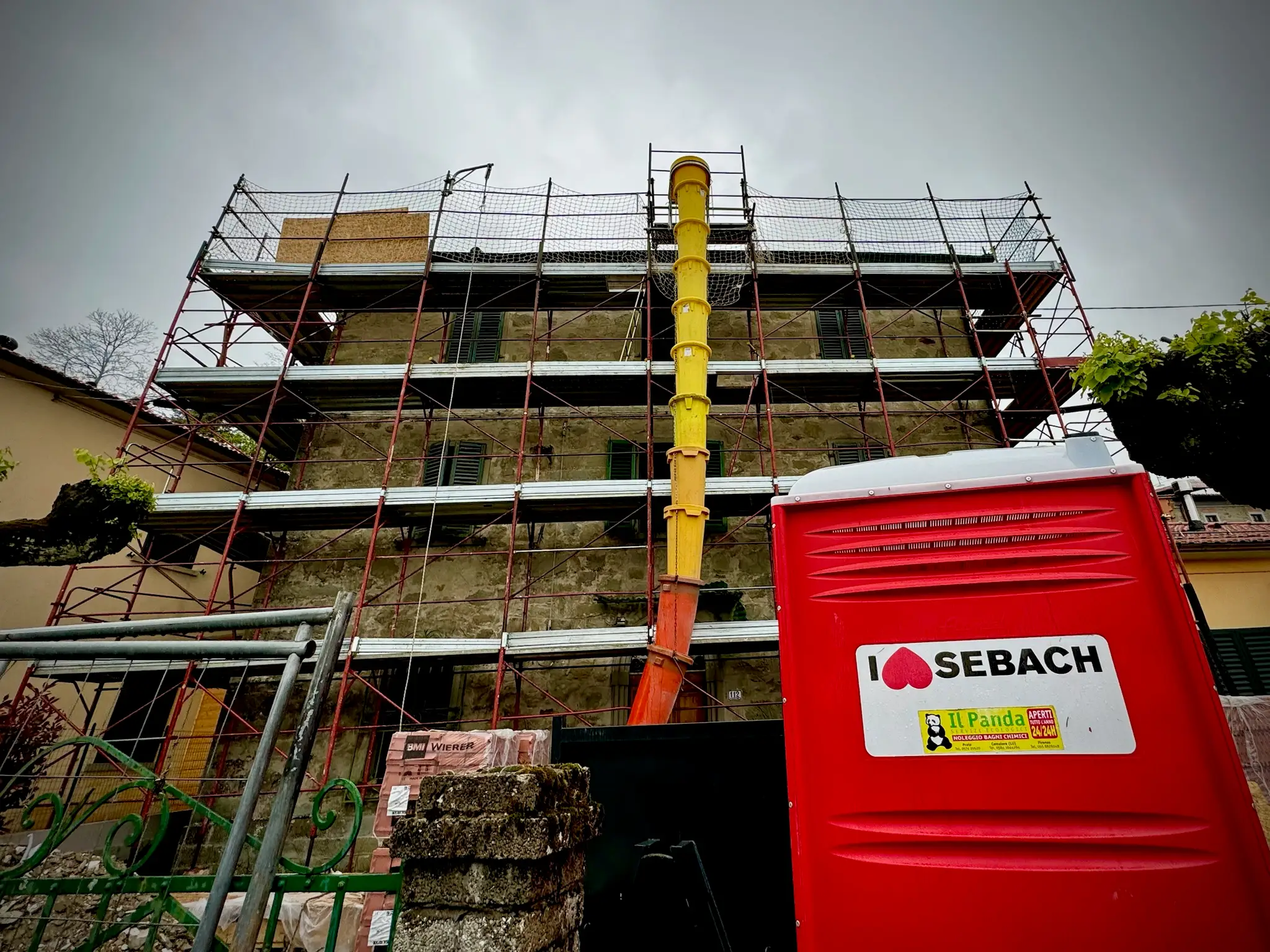 Villa with scaffolding, construction otside of it