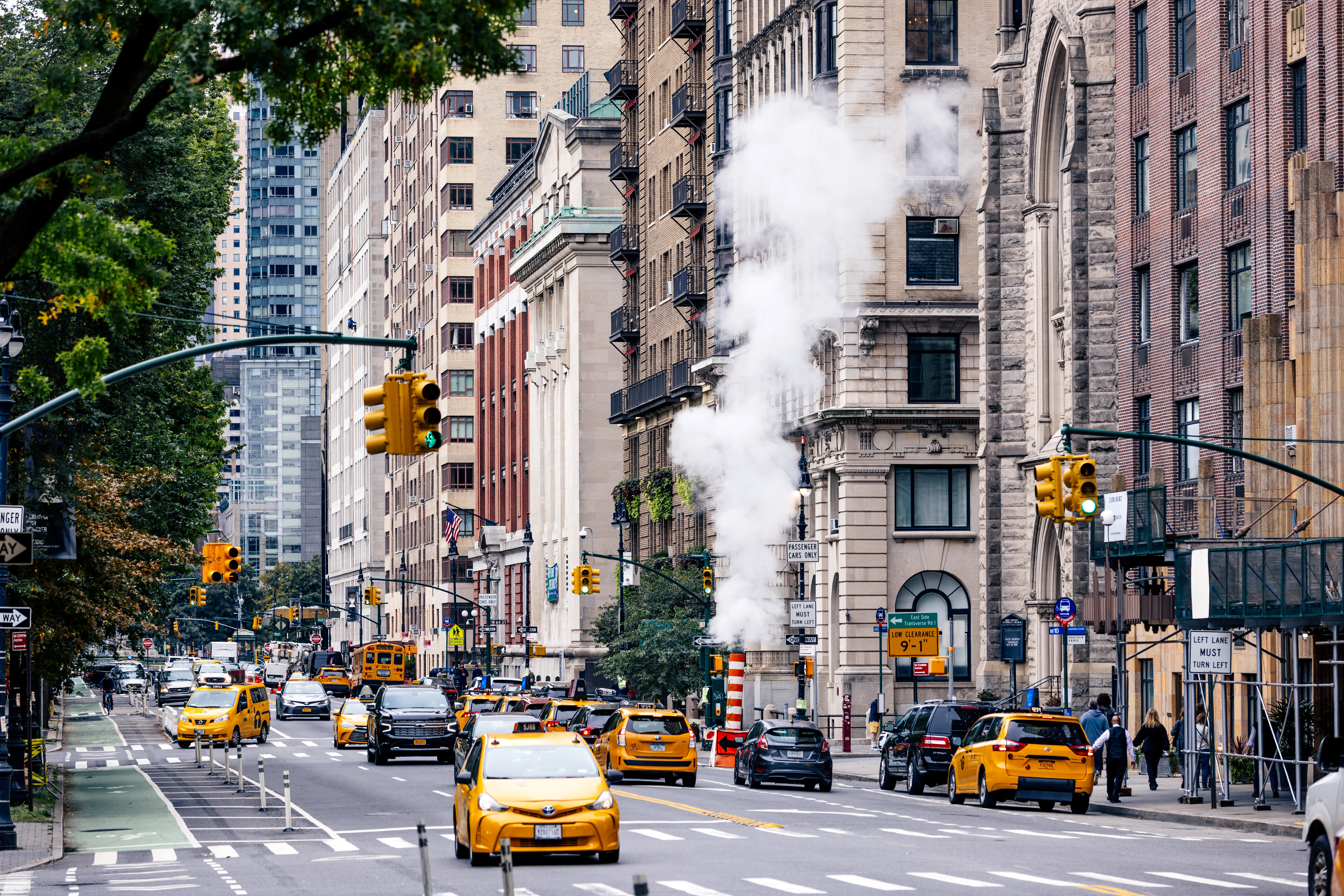 Taxis, cars driving through New York City street