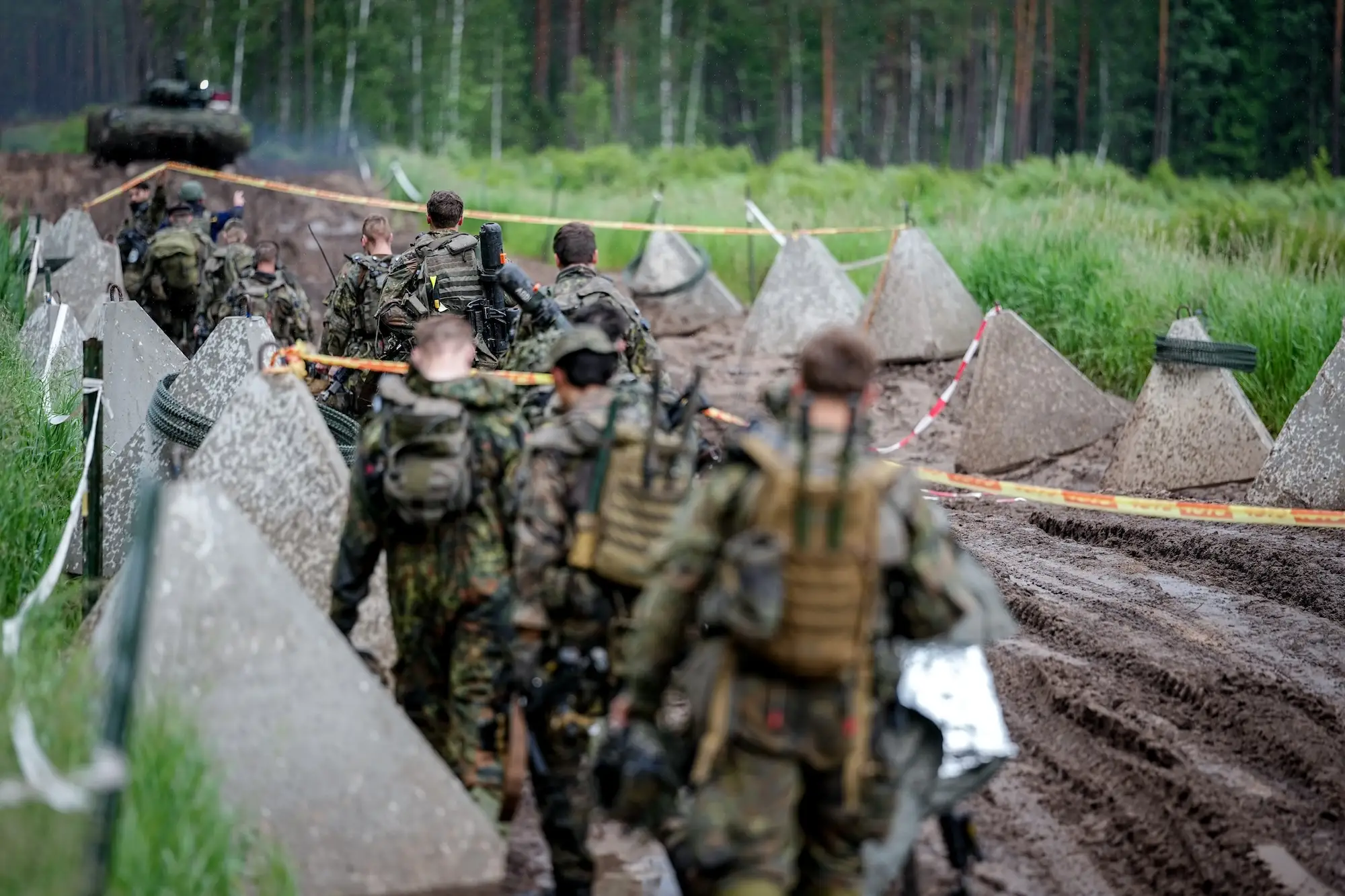 German soldiers cross a path lined with anti-tank dragon's teeth during a June exercise in Lithuania.