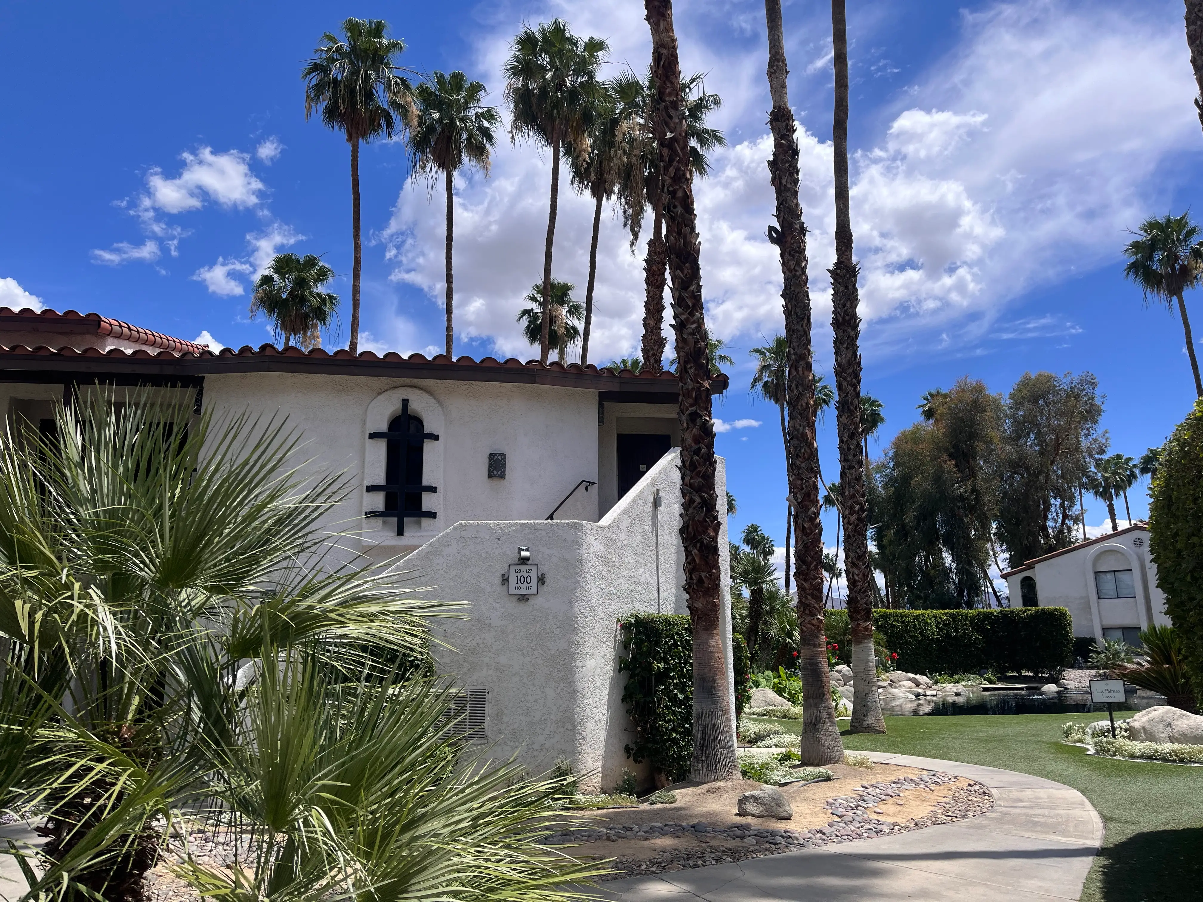 View of building next to palm trees