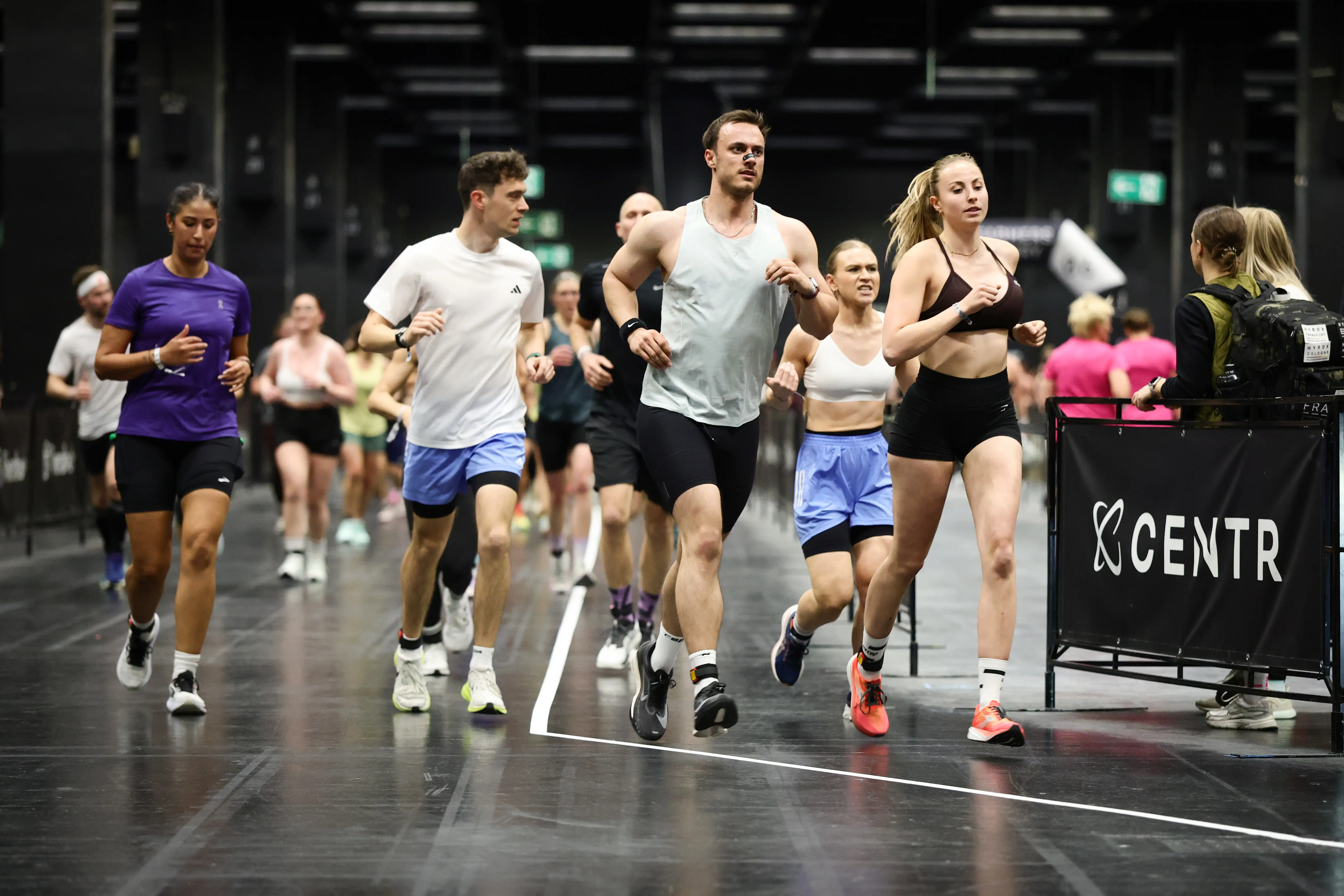 Athletes run during a Hyrox event