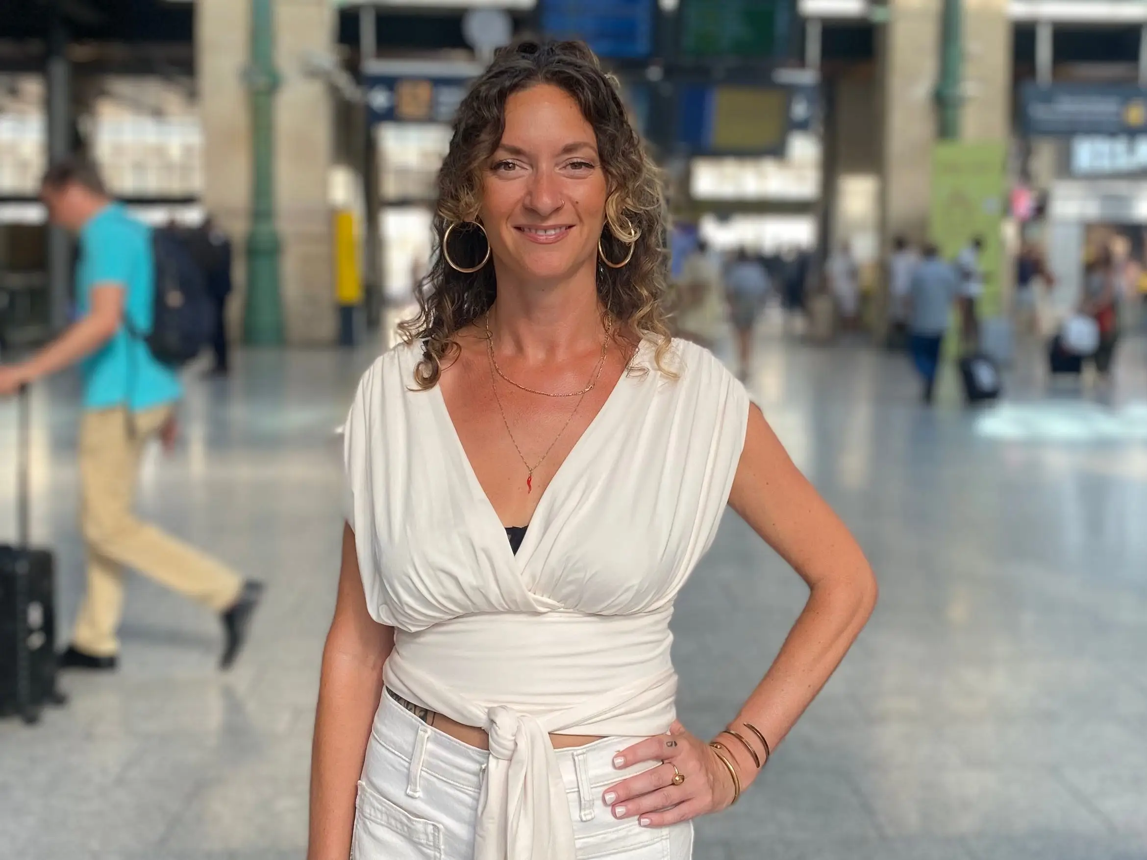 Woman posing in airport with hand on hip