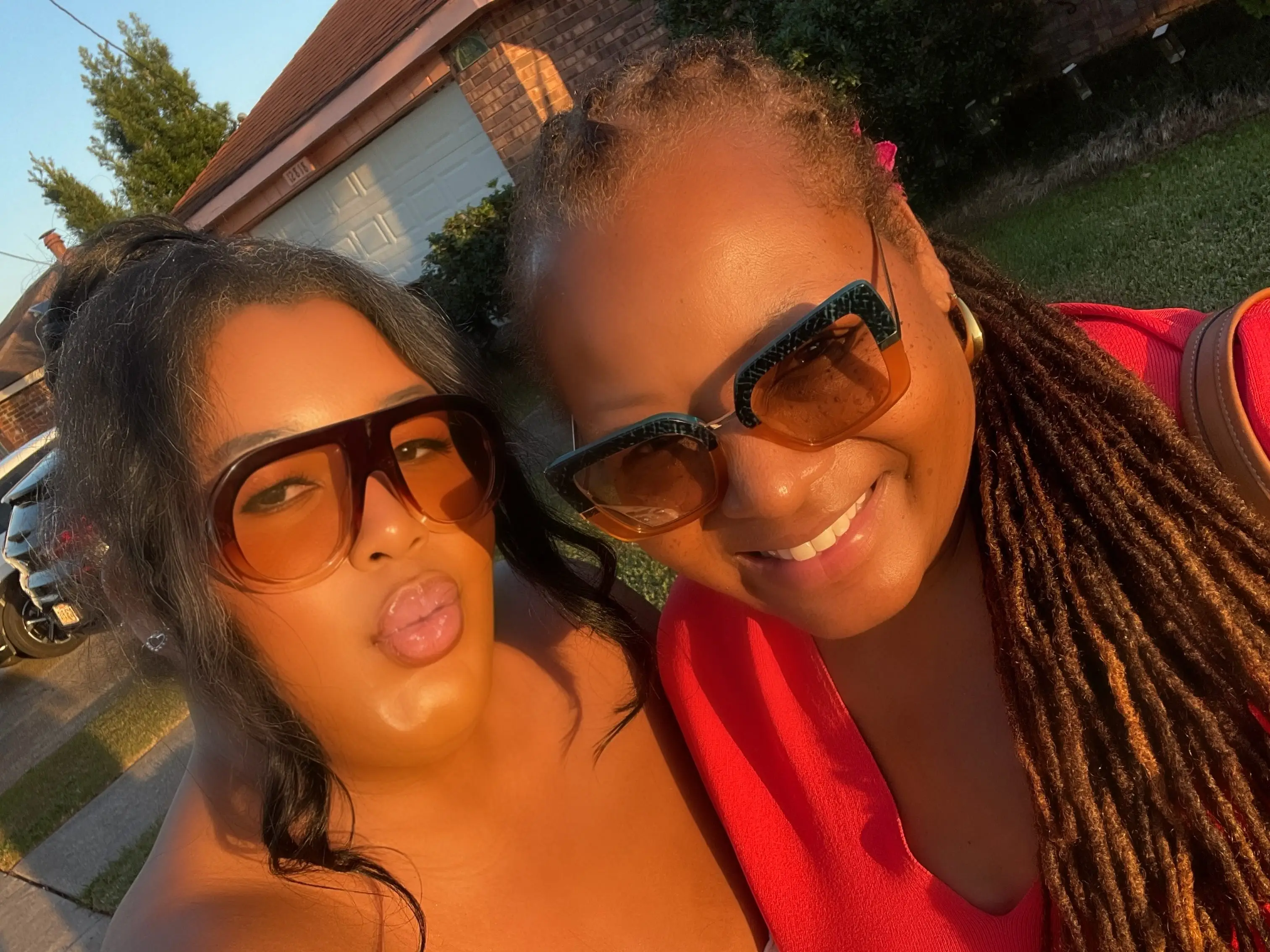 A selfie of a mother and daughter wearing sunglasses.