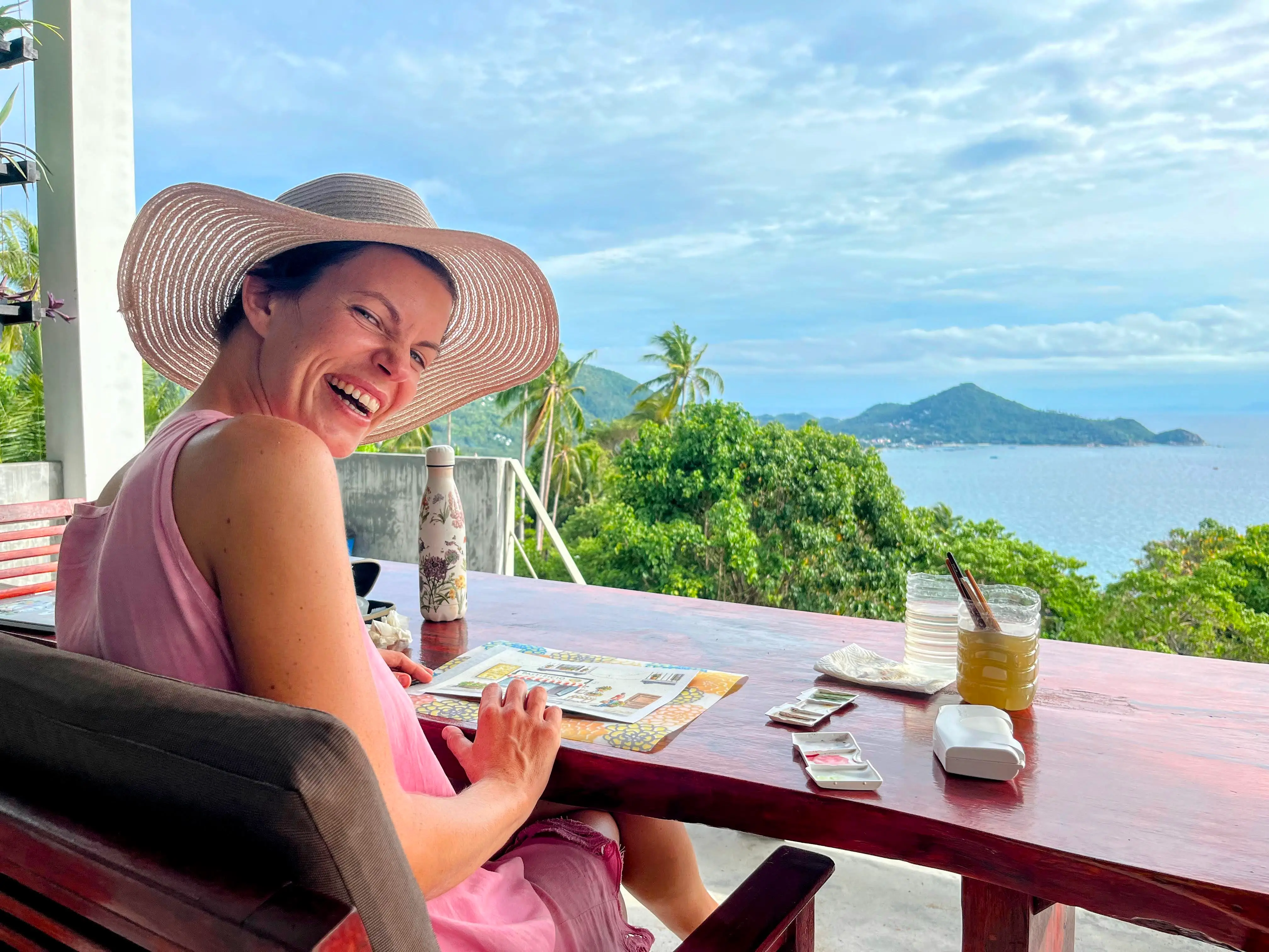 A woman painting on an island in Thailand.