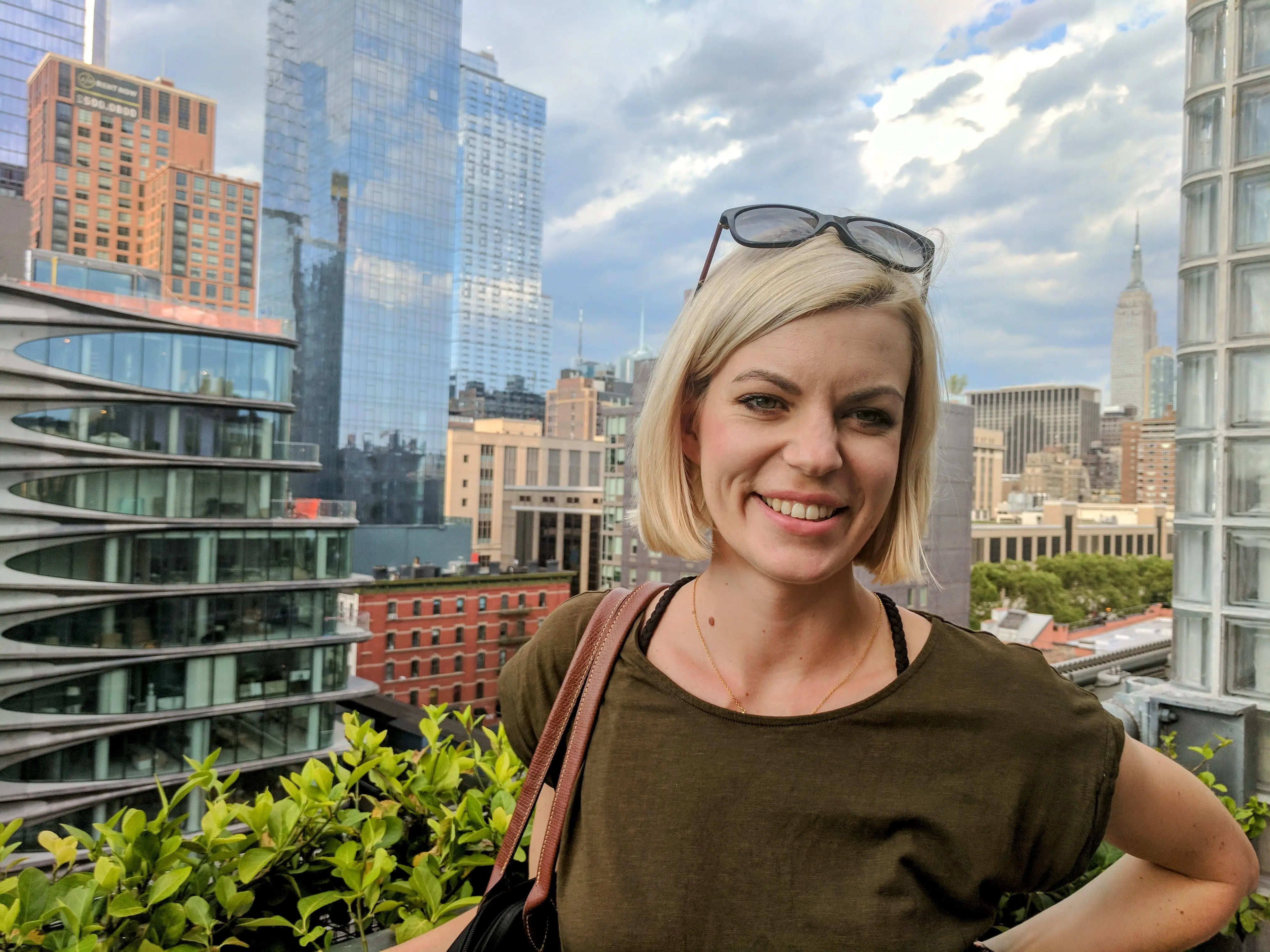 A woman standing with New York City in the Background.