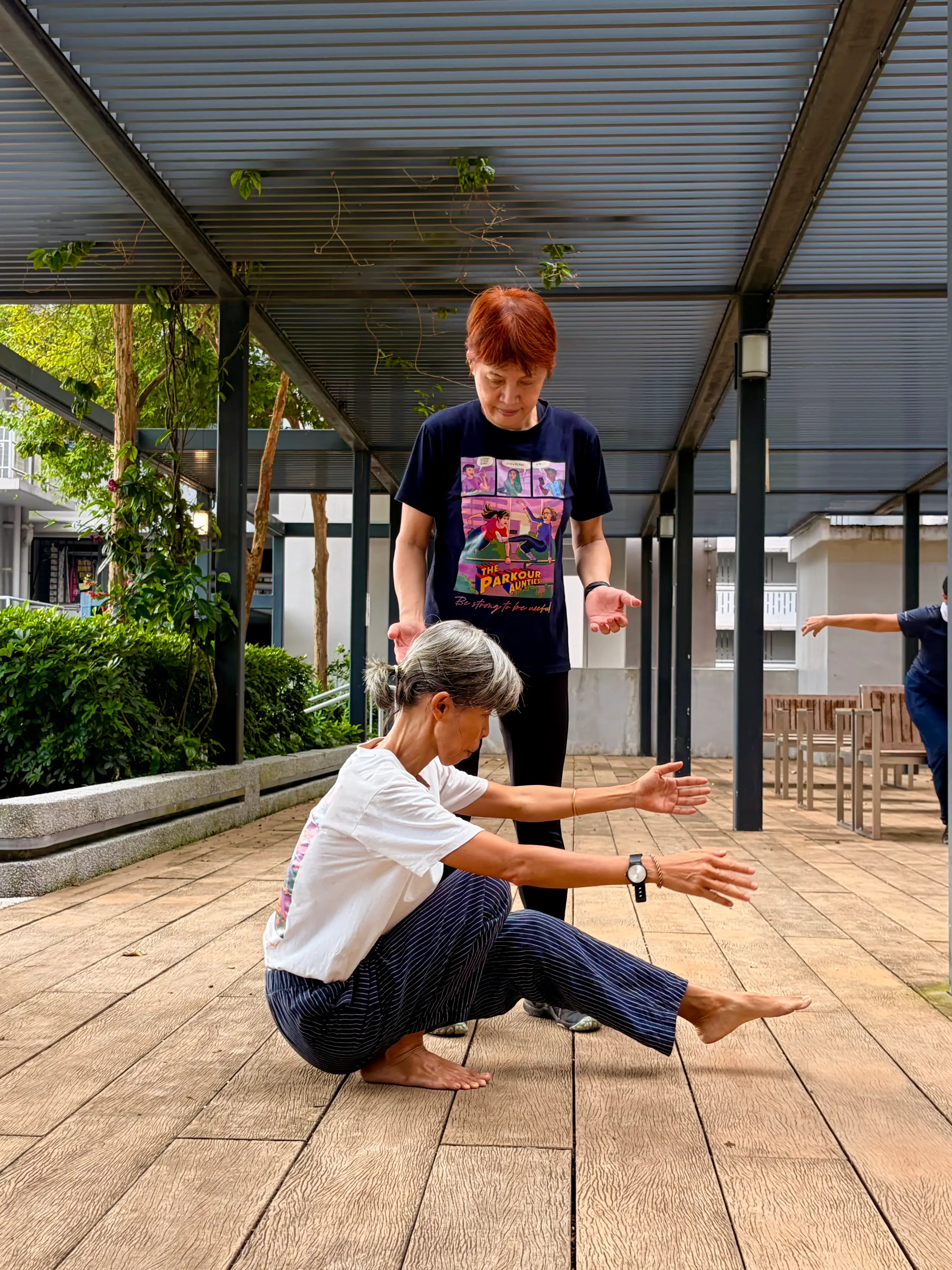 A woman doing a single-leg squat, unassisted.