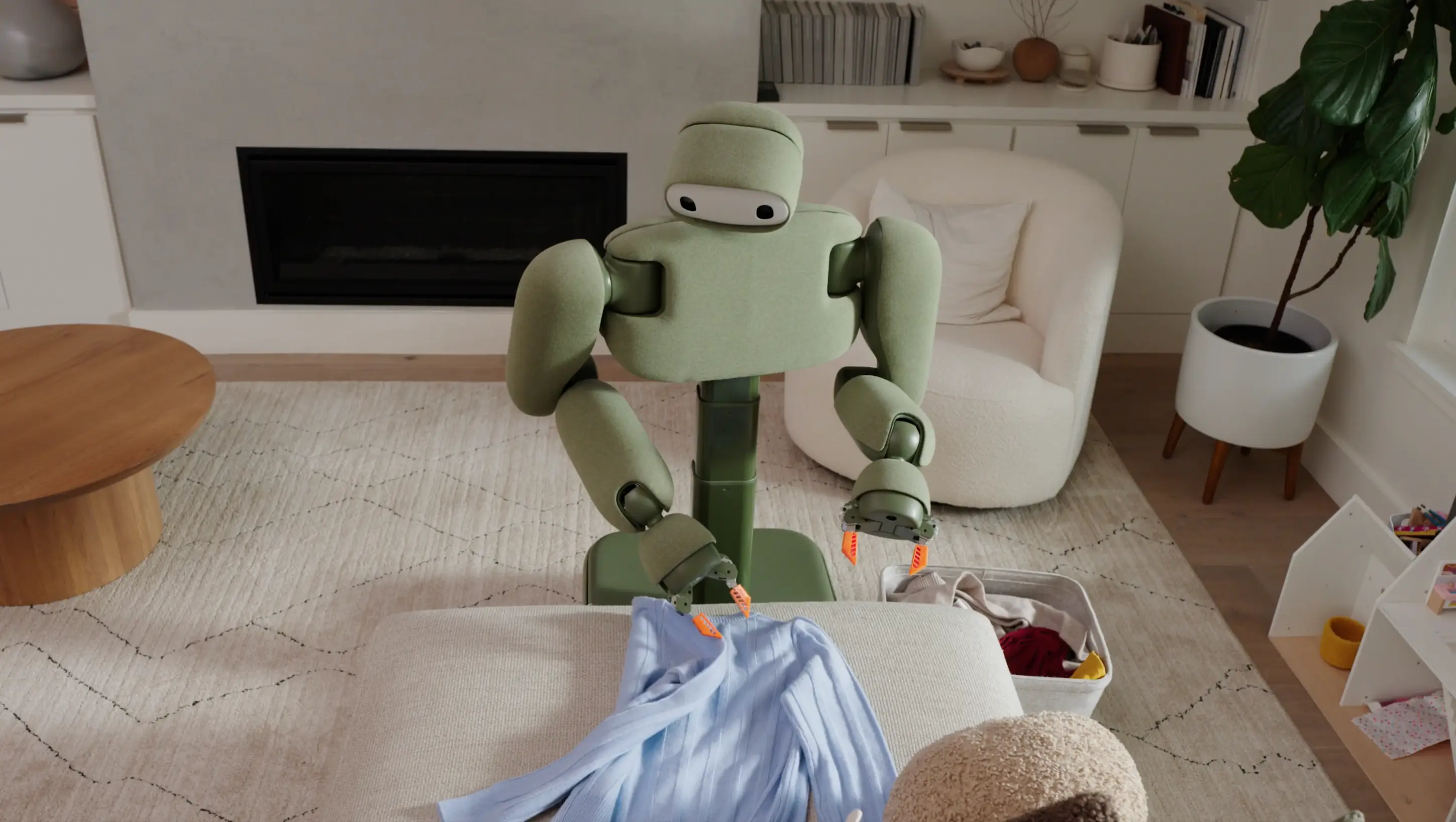 Isaac 1, a humanoid robot, folds a blue top.