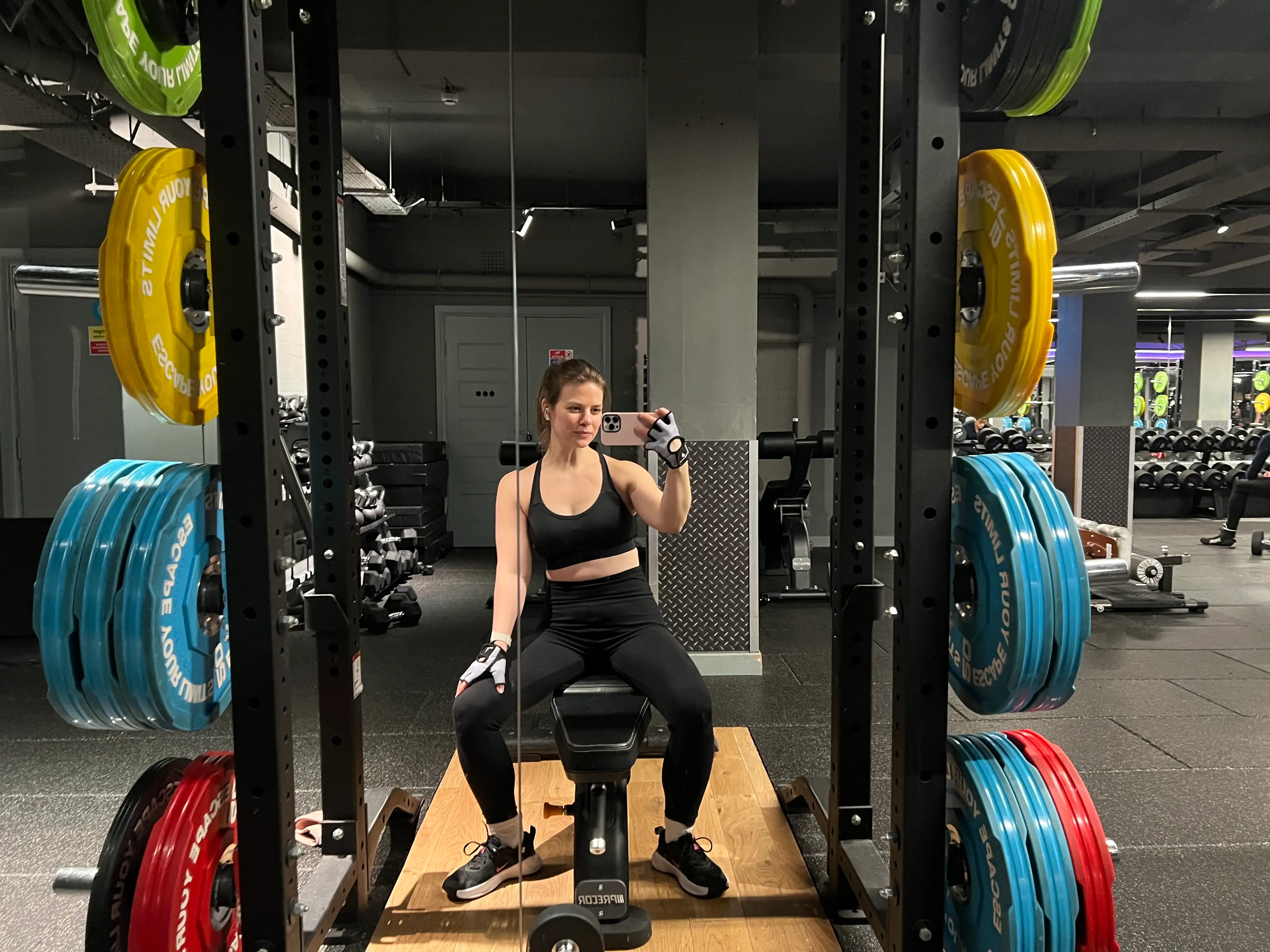 The author sits at a squat rack at the gym