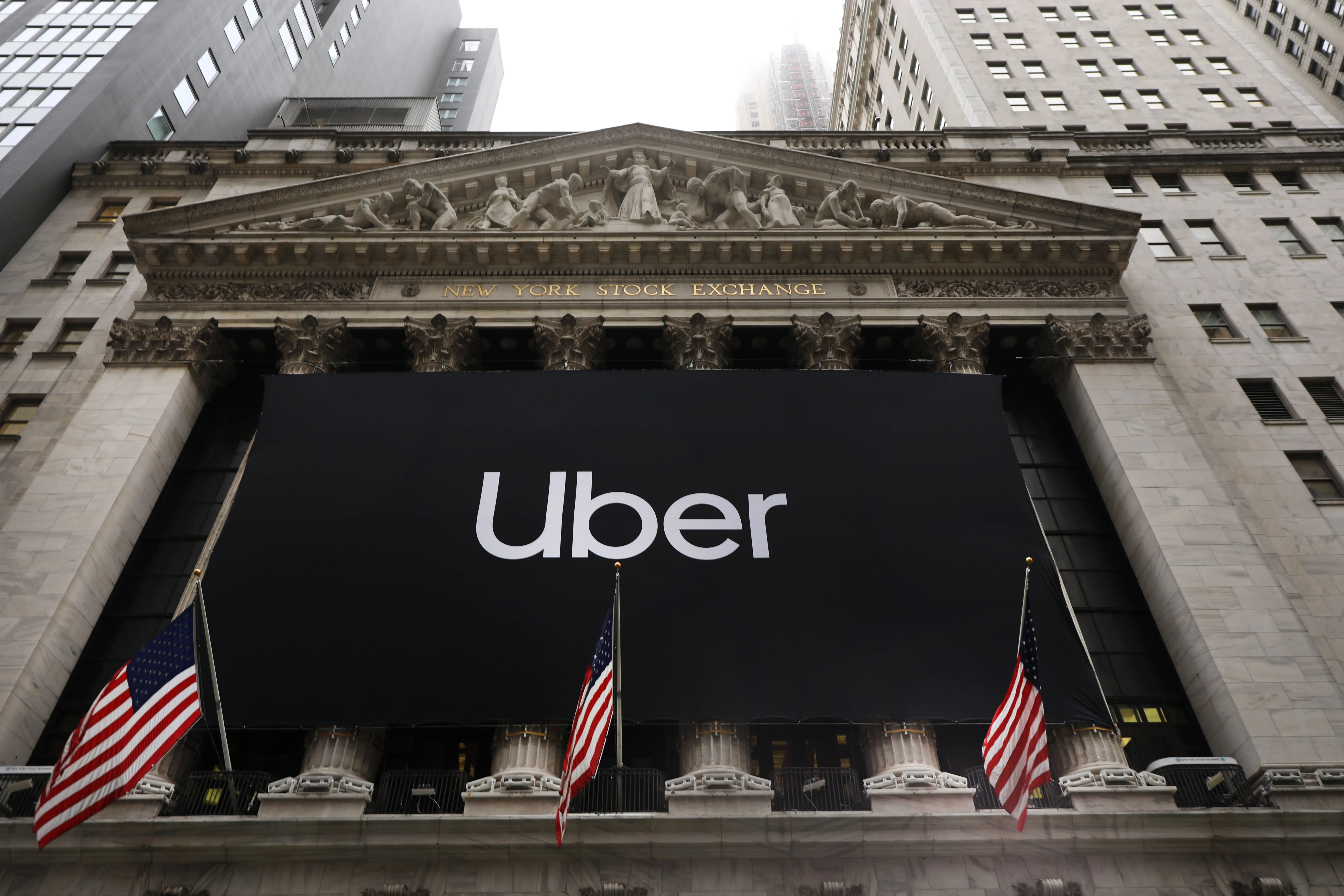 A black-and-white Uber banner hangs over the columns at the New York Stock Exchange building.