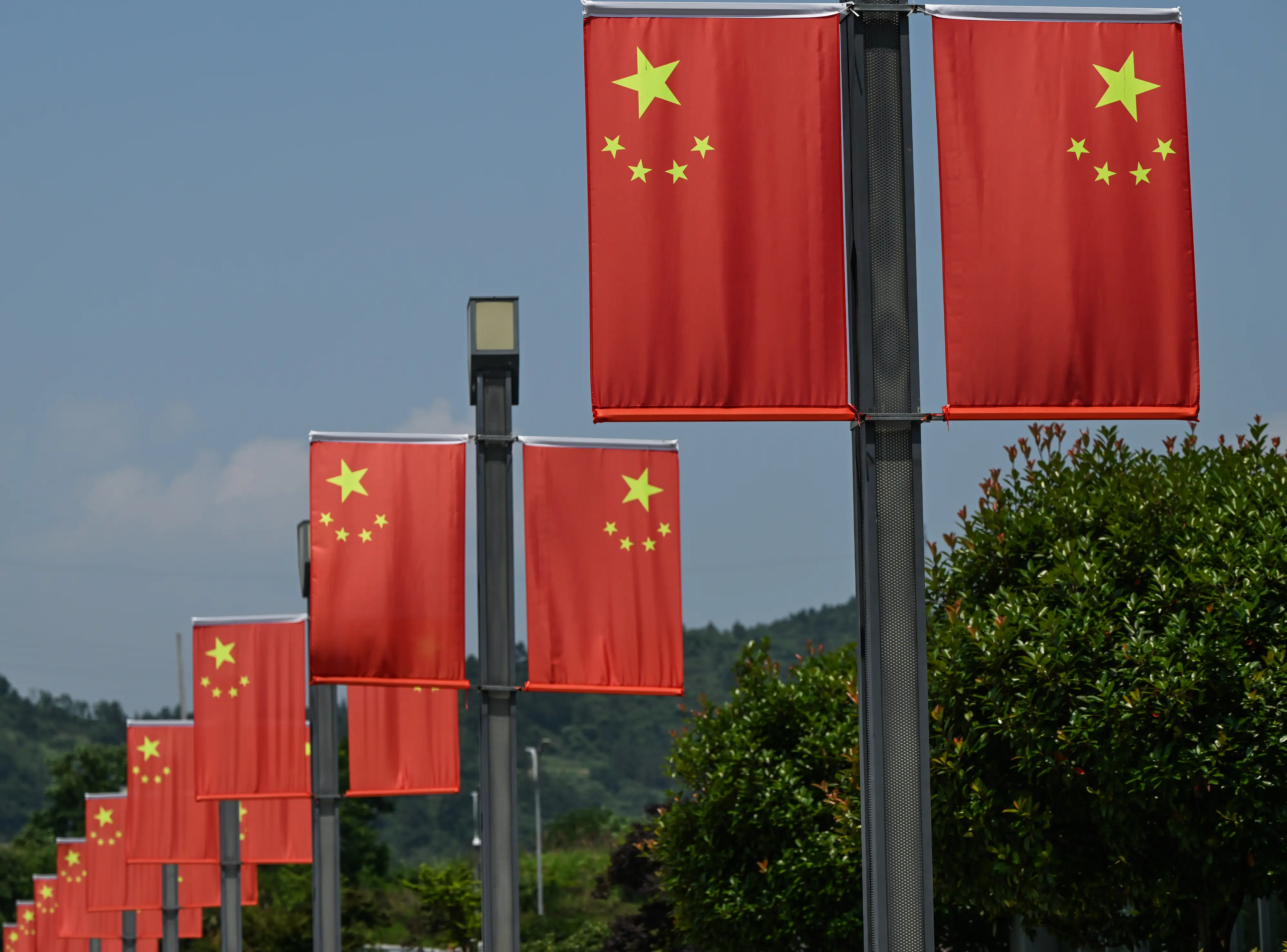 A row of Chinese flags is pictured.