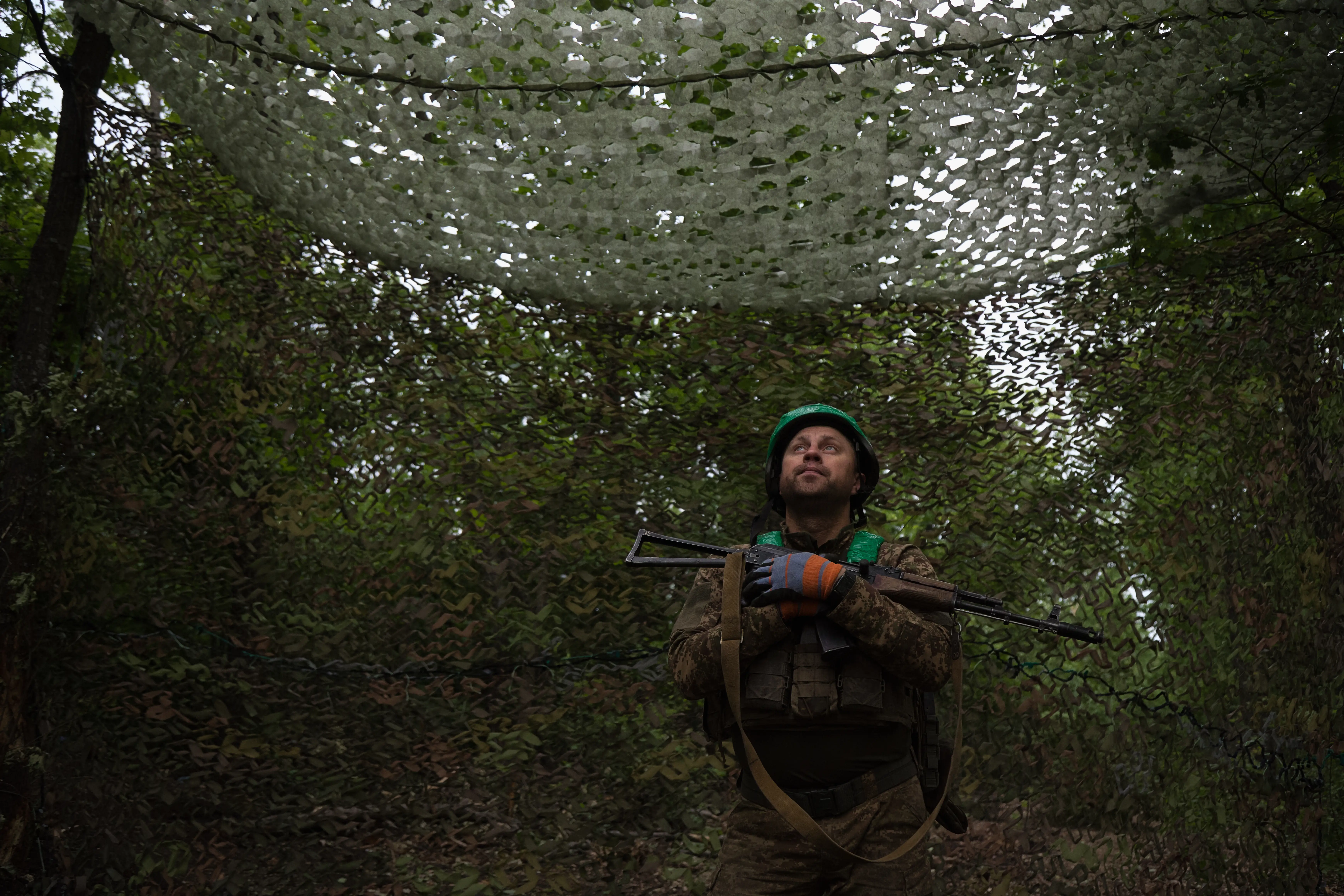 Servicemen of the 15th Operational Brigade Kara-Dag, an elite assault unit of the National Guard of Ukraine, scan the sky for a detected Russian FPV drone after firing a 2S22 Bohdana self-propelled howitzer near Pokrovsk in the Donetsk region on May 27, 2026, in Pokrovsk, Ukraine.