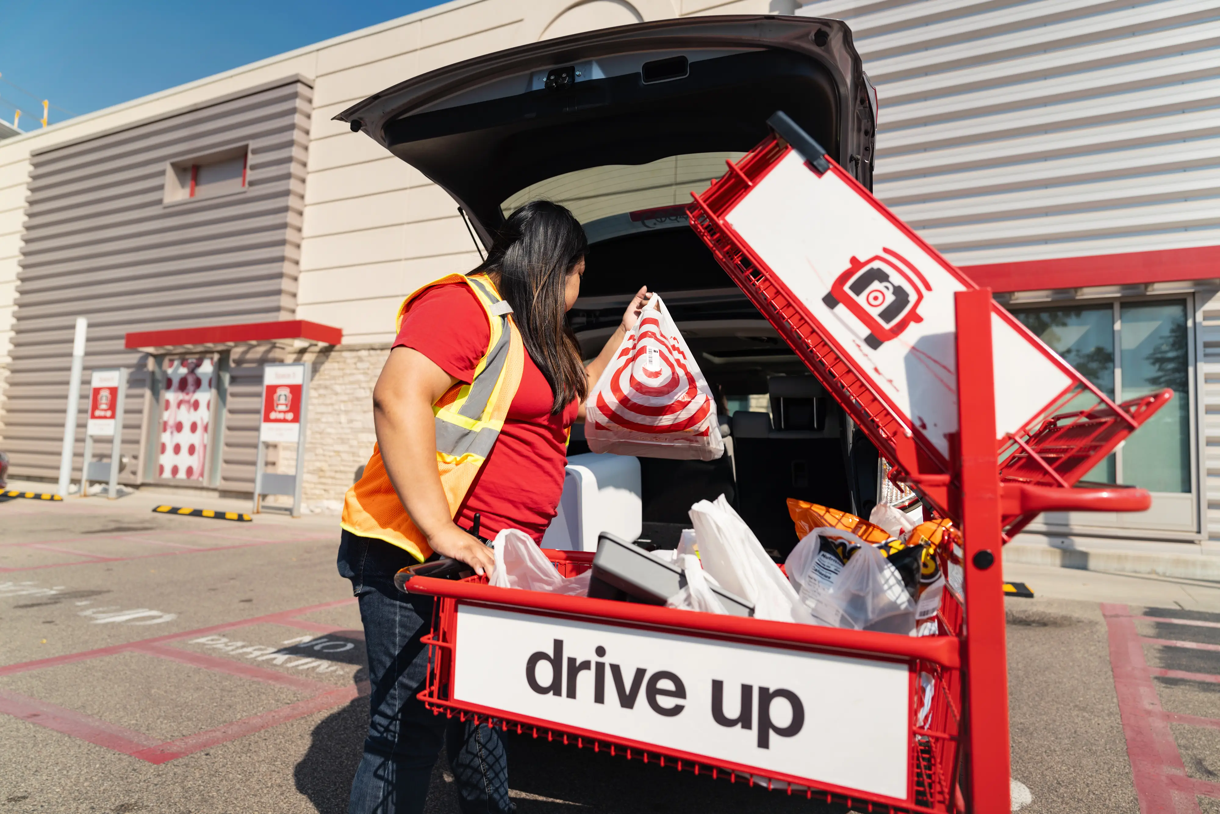 A Target Corp. employee loads products into a vehicle at the drive-up pickup location outside the company's flagship store in Edina, Minnesota, US, on Thursday, Sept. 5, 2024.