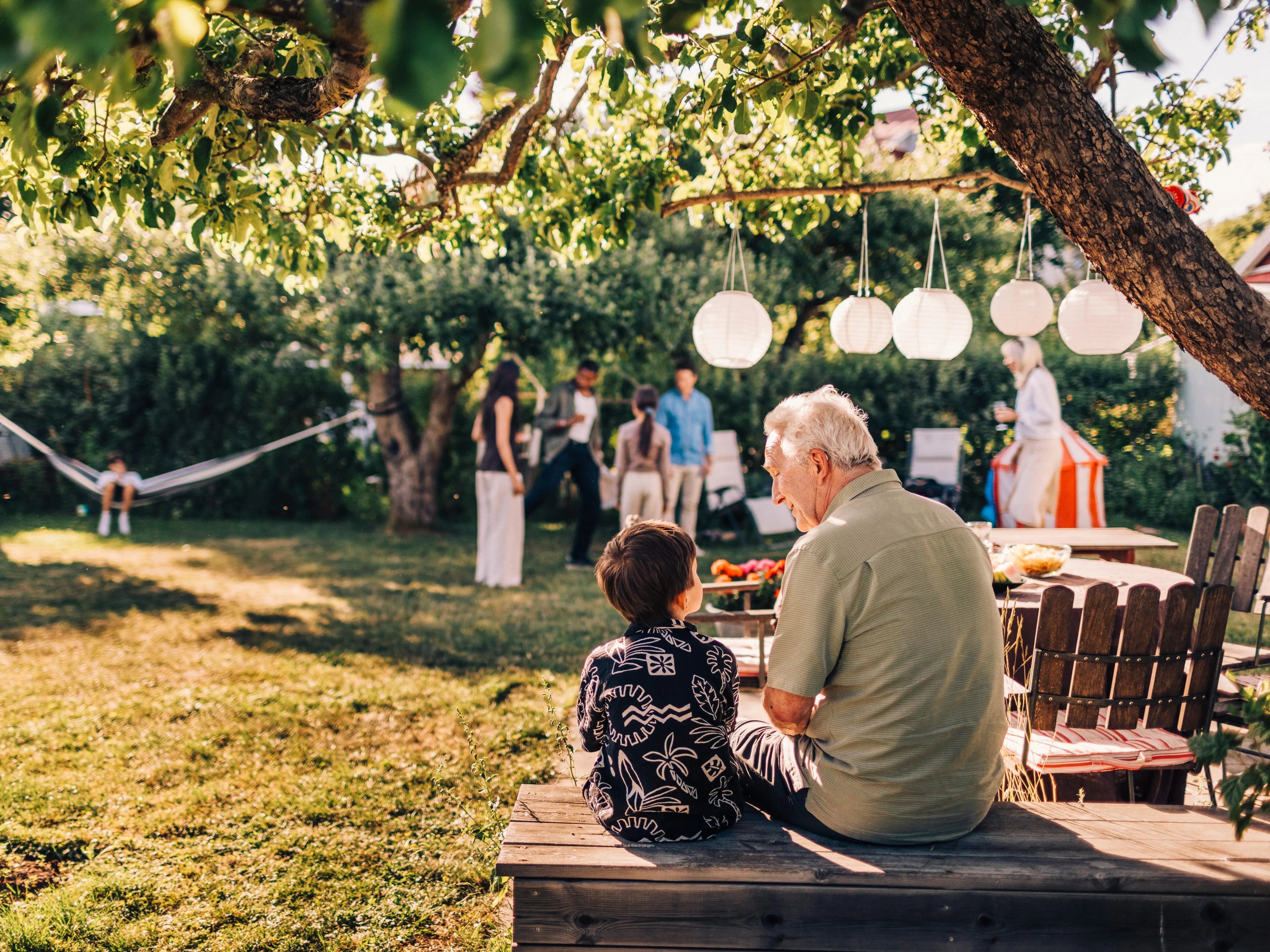 A grandfather sitting with his grandson.