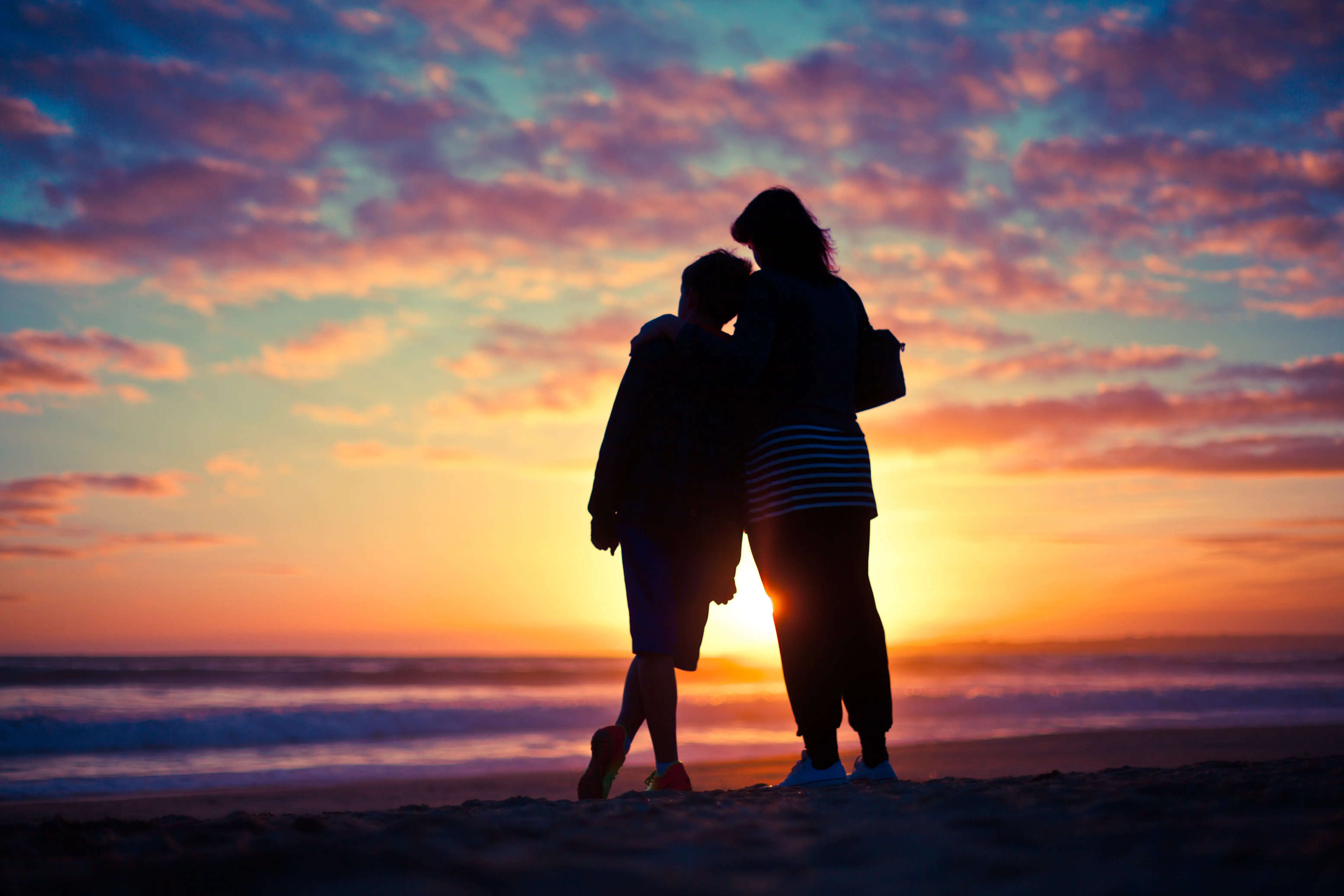 Parent with child sunset