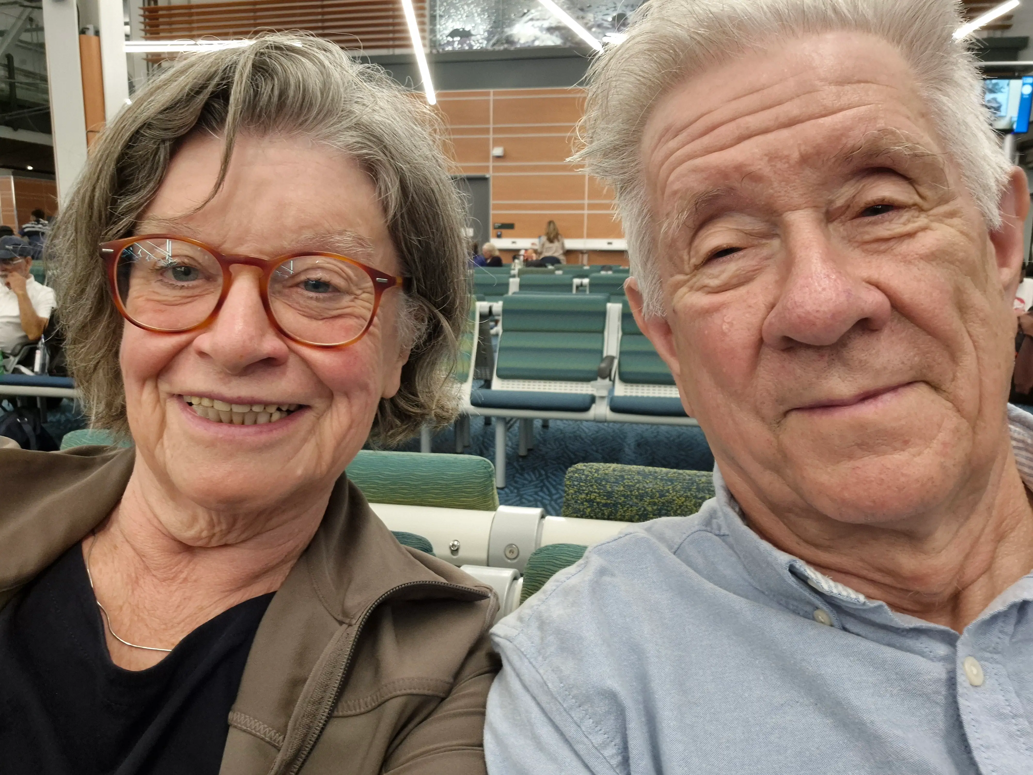 Two people smiling for selfie in classroom