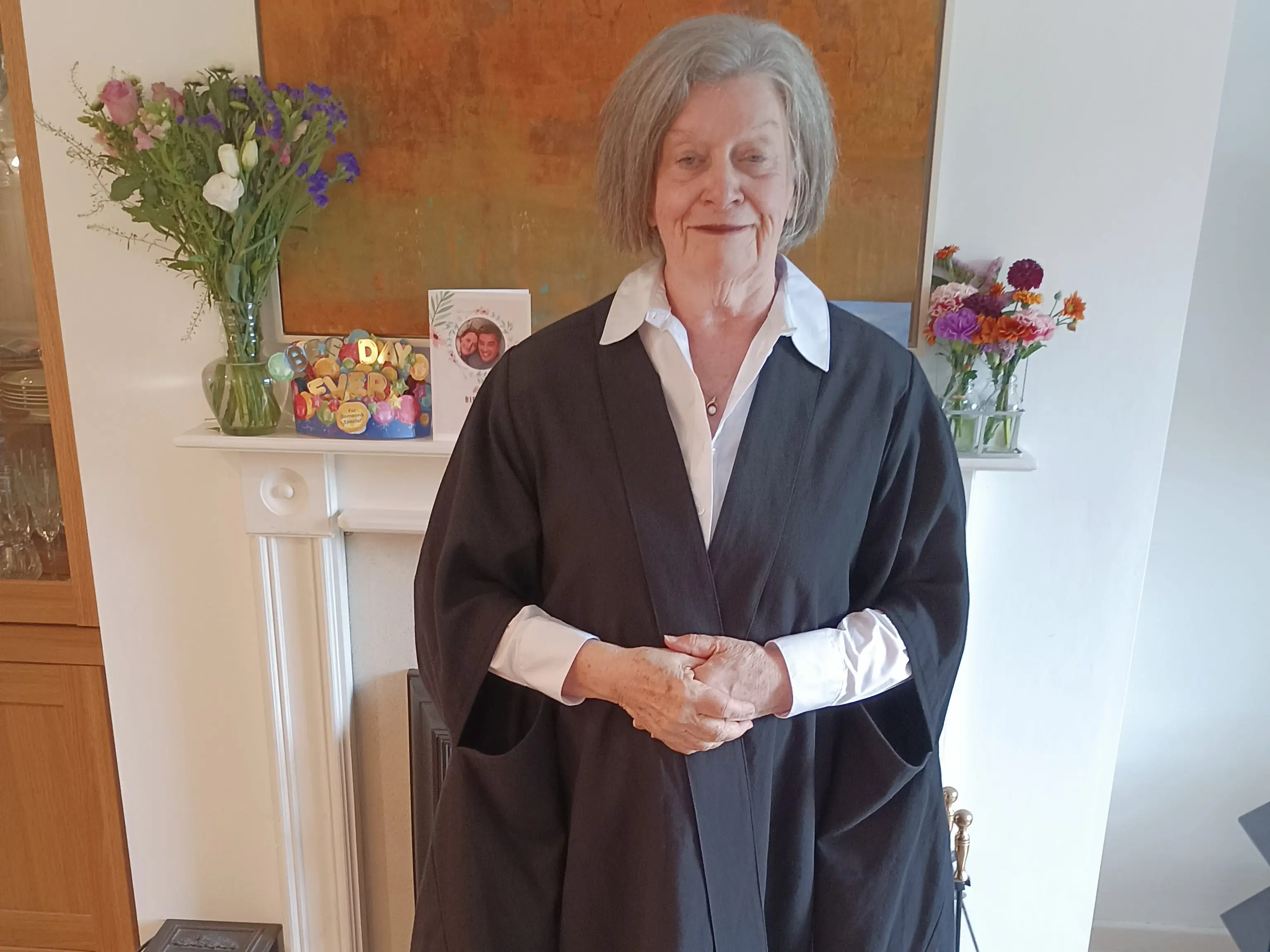Woman in graduation robe smiling