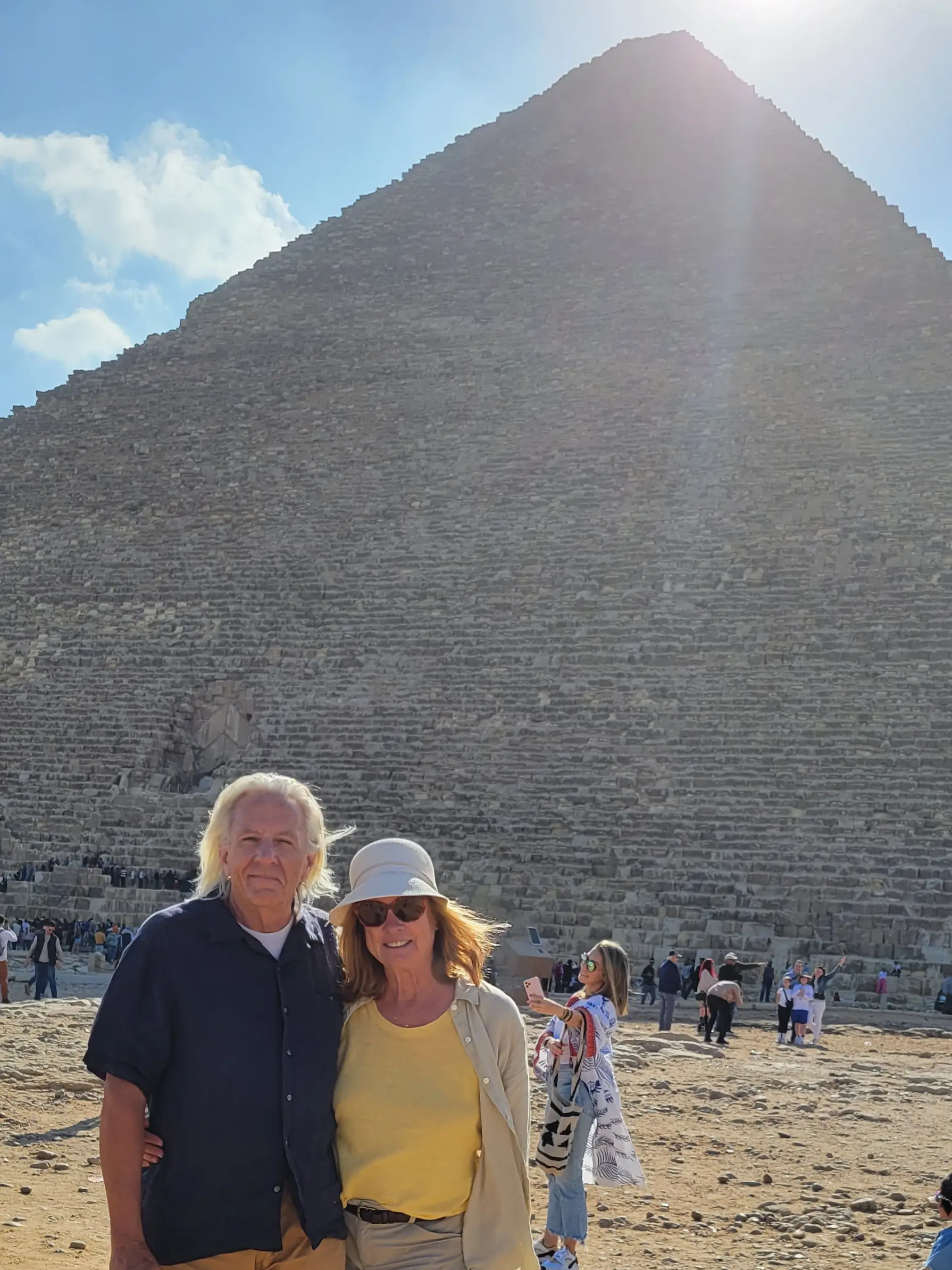 A couple posing in front of the Great Pyramids of Giza.