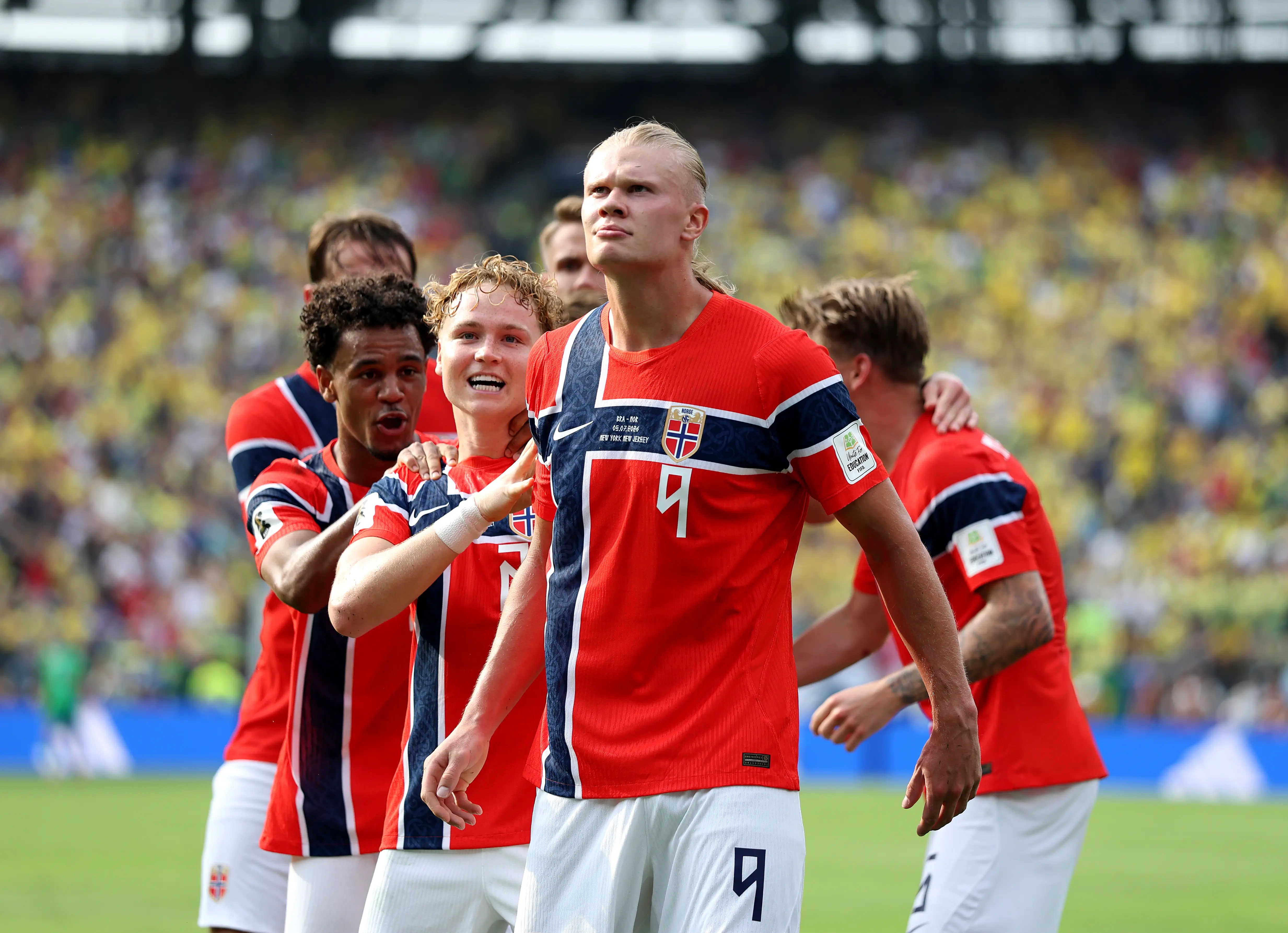 Erling Haaland celebrates with teammates after scoring a goal.