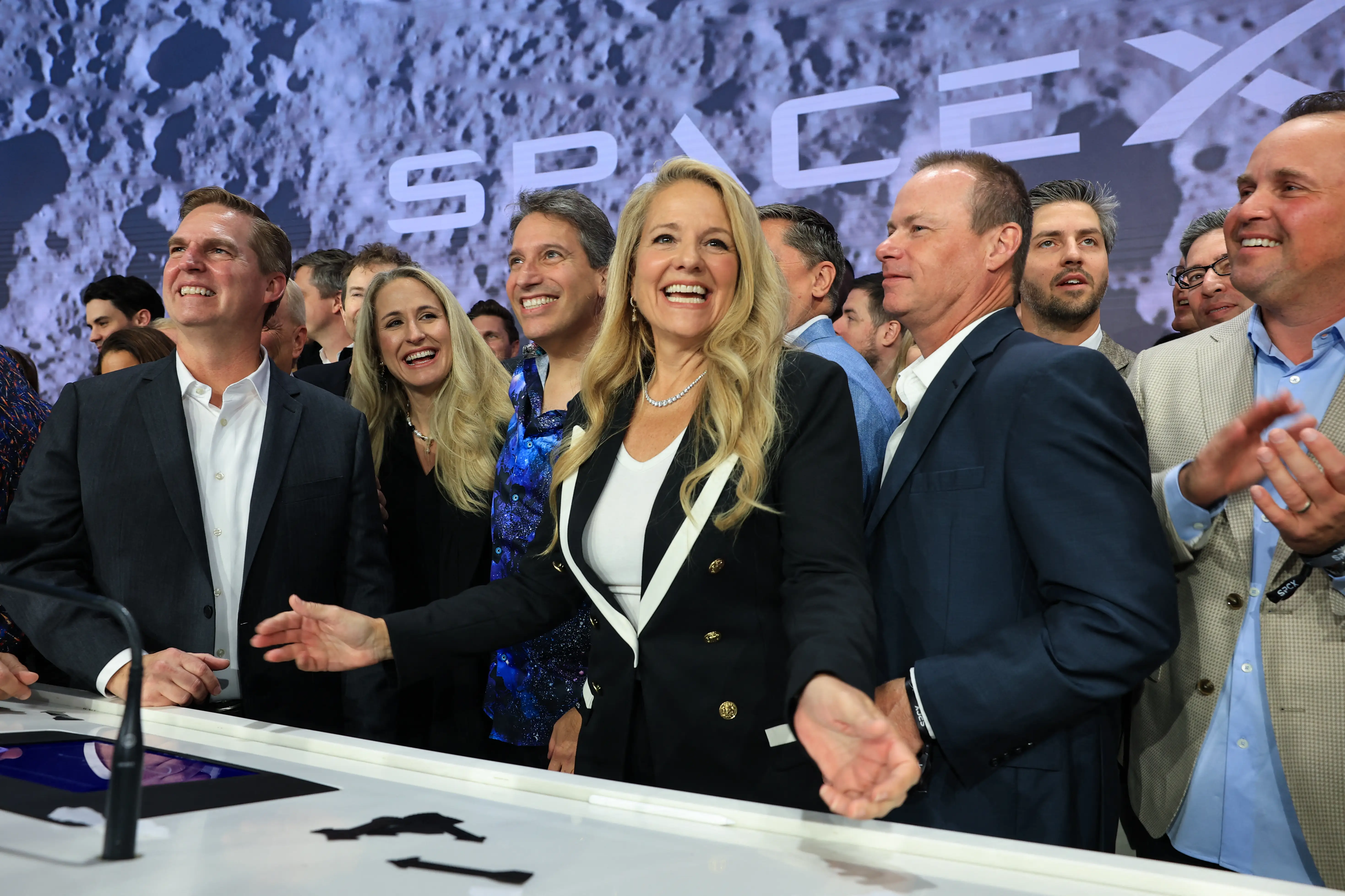 gwynne shotwell in front of spacex logo