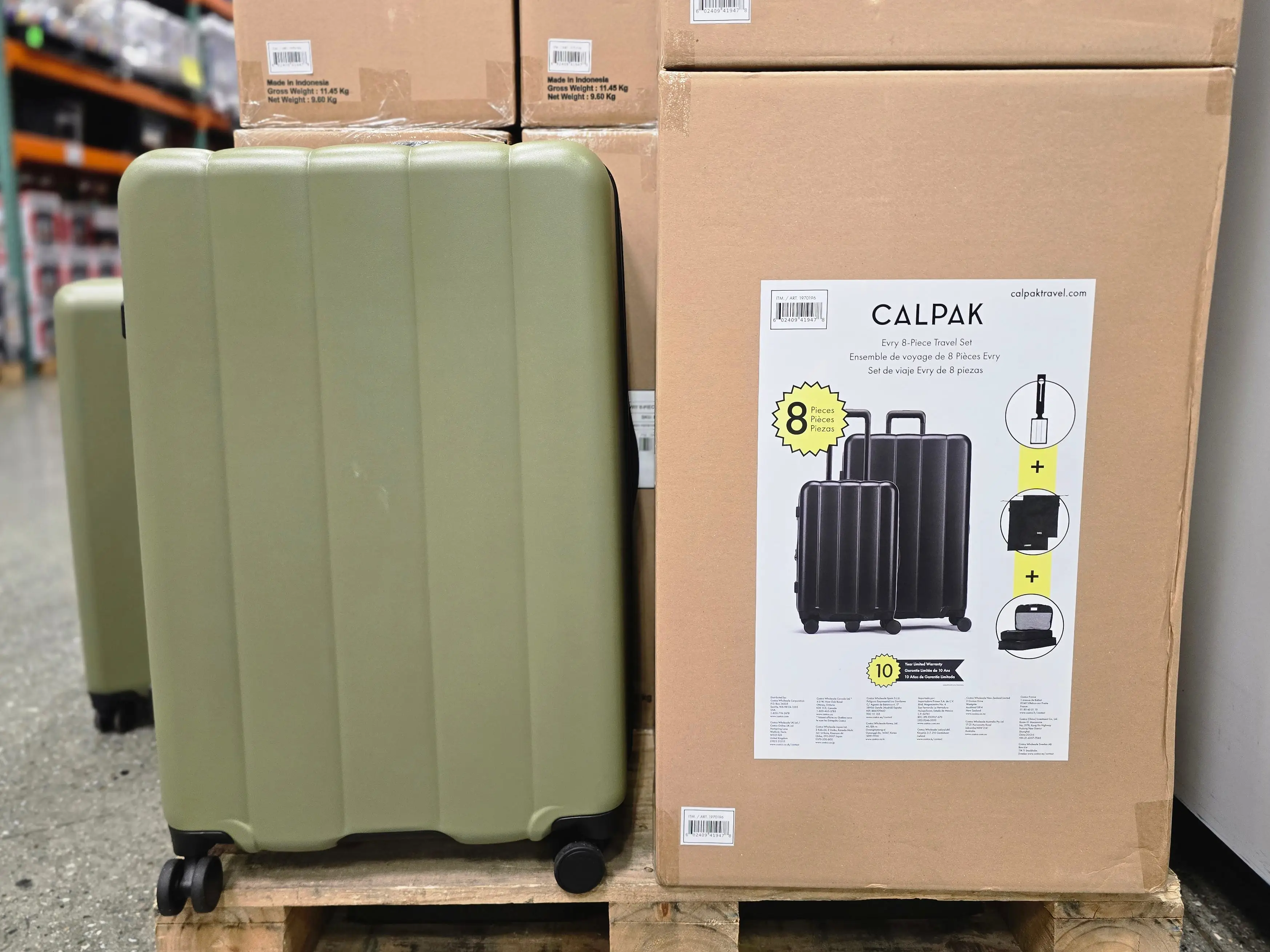 A green Calpak rolling suitcase on display at Costco.