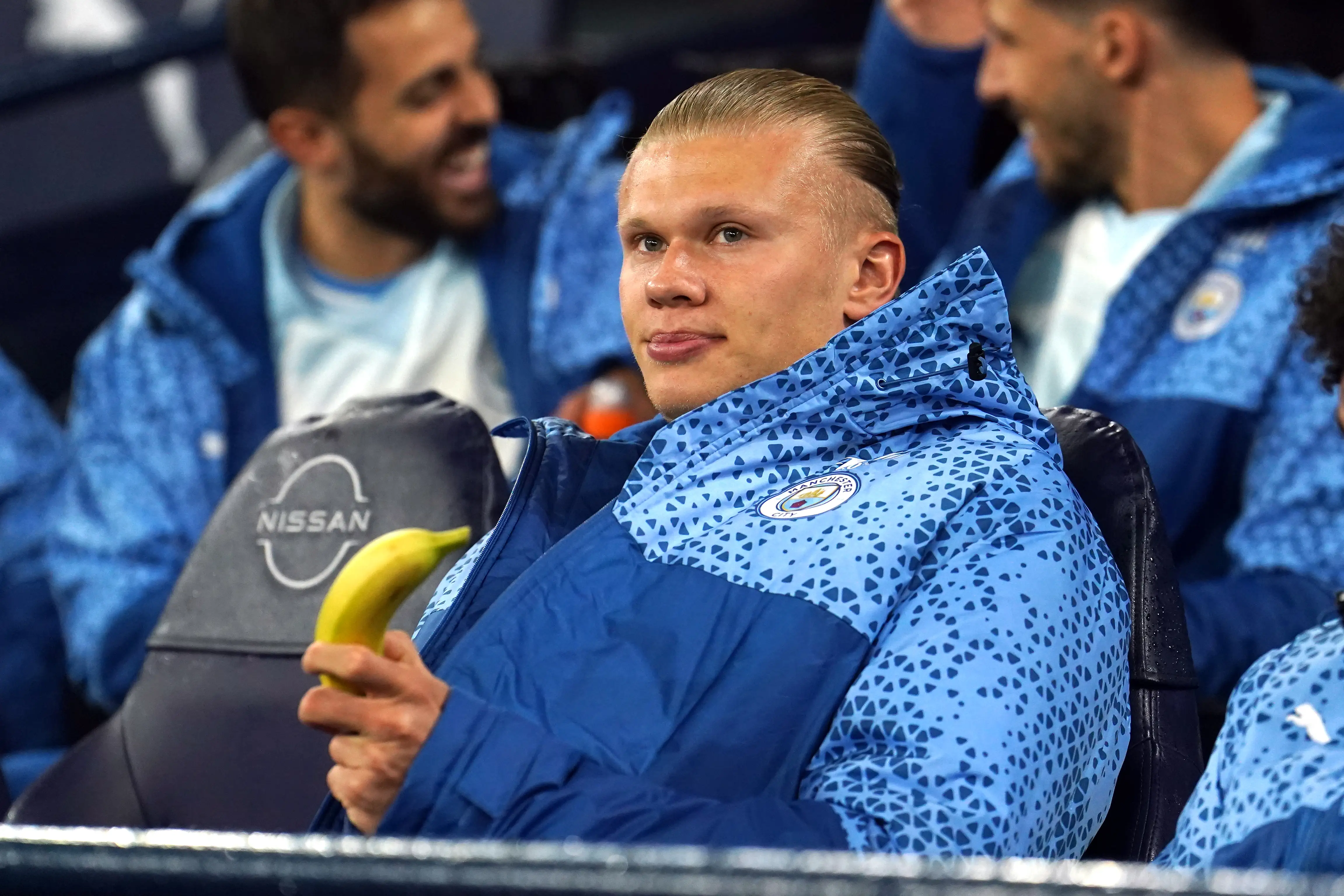 Manchester City's Erling Haaland holds a banana while on the bench before the Premier League match at the Etihad Stadium, Manchester.