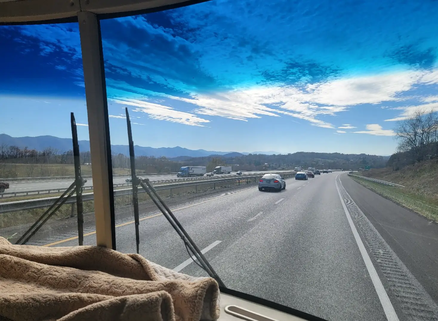 A view of the highway, with mountains in the background, from the writer's car.