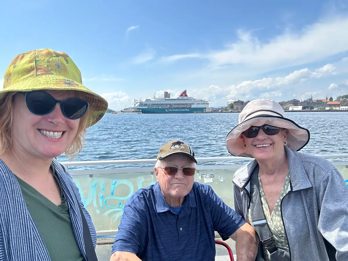 Woman smiling with parents at Oslo waterfront