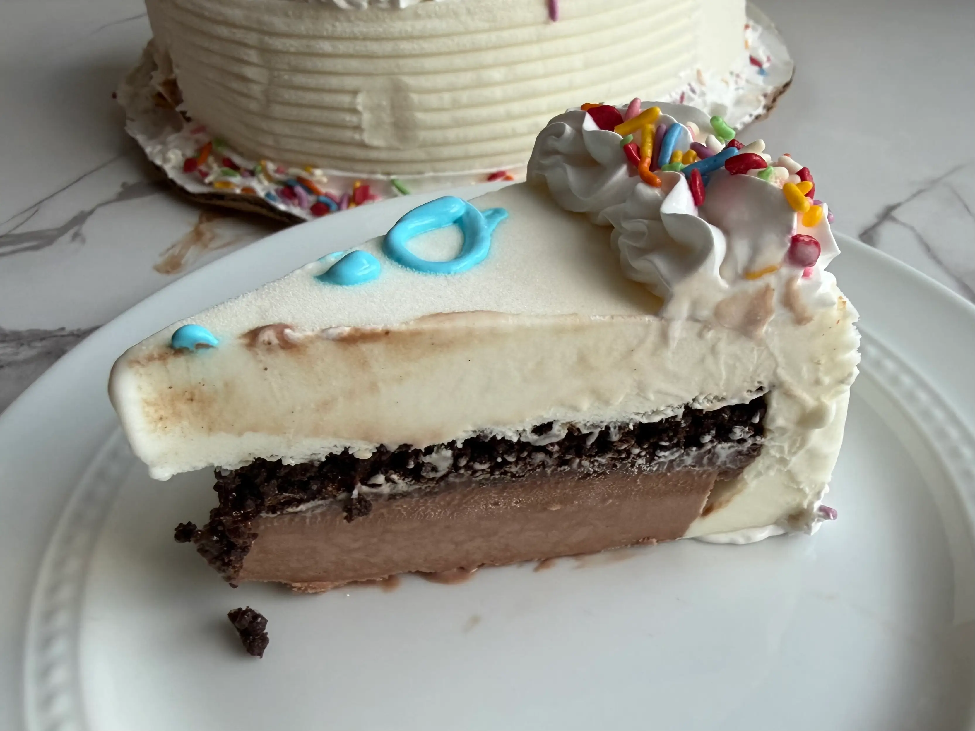 Slice of Dairy Queen ice cream cake with chocolate, fudge crunch, and vanilla layers