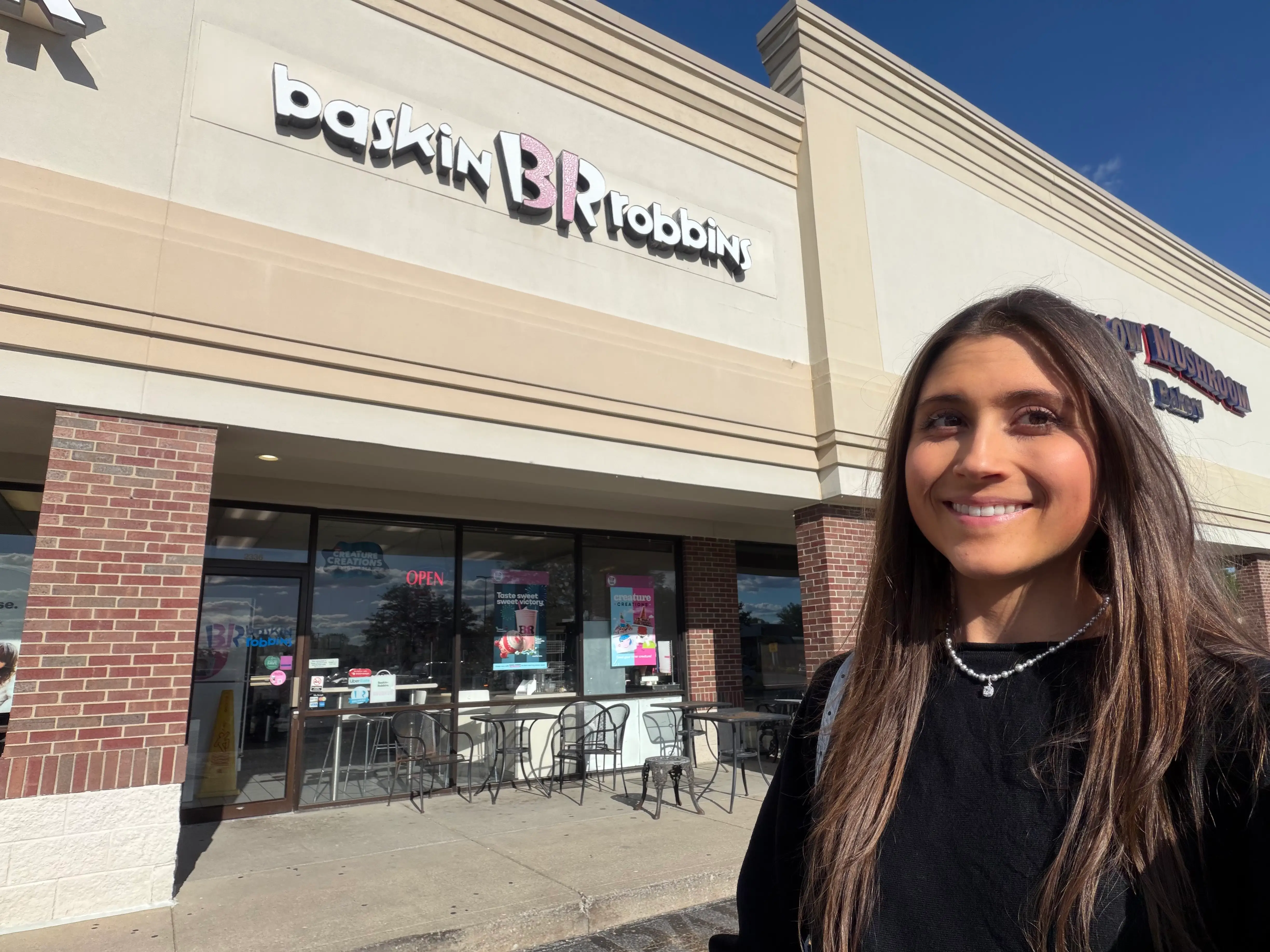 Woman smiling outside of Baskin Robbins