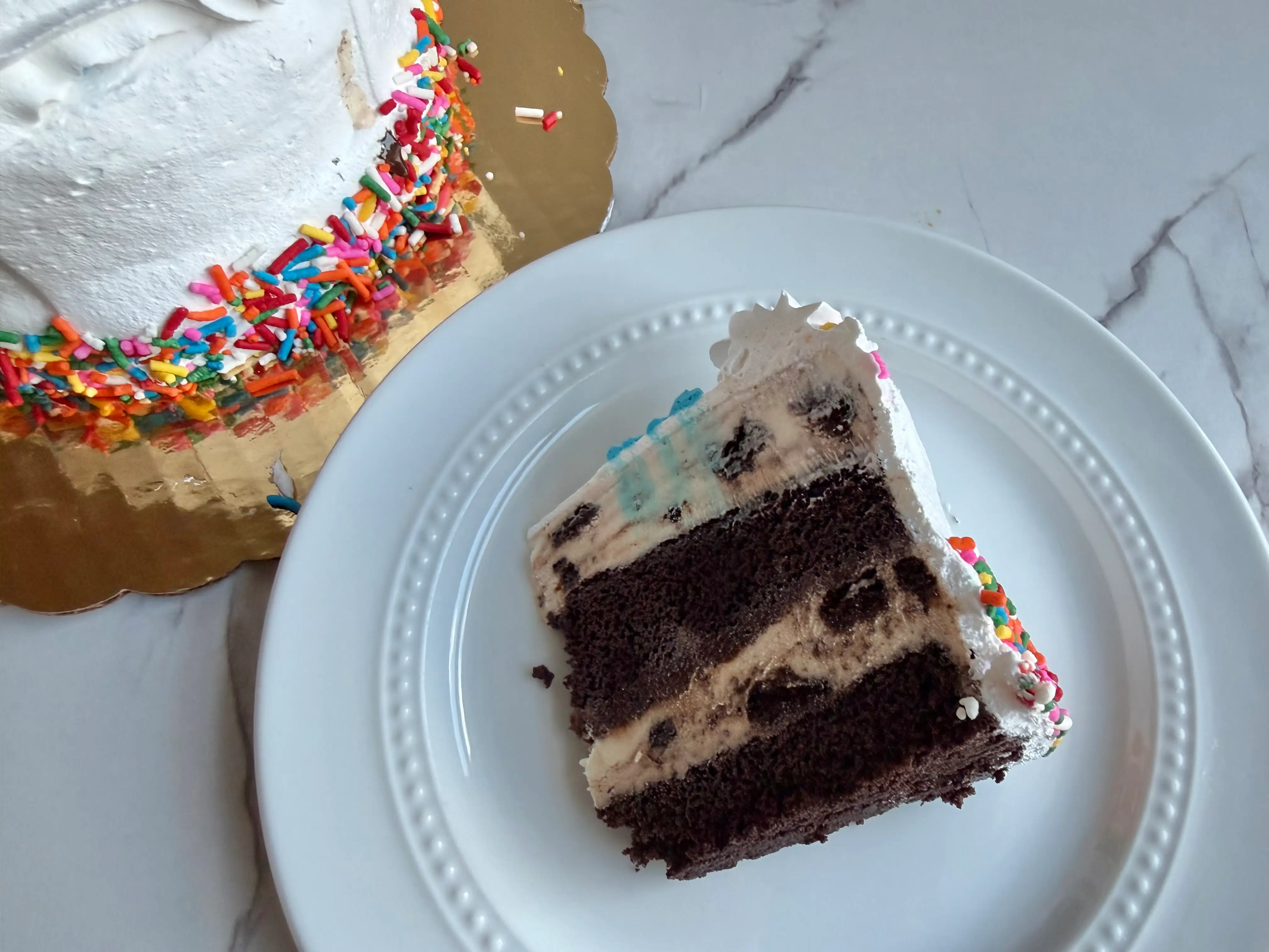 Slice of Dairy Queen ice cream cake with chocolate, fudge crunch, cake, and vanilla layers