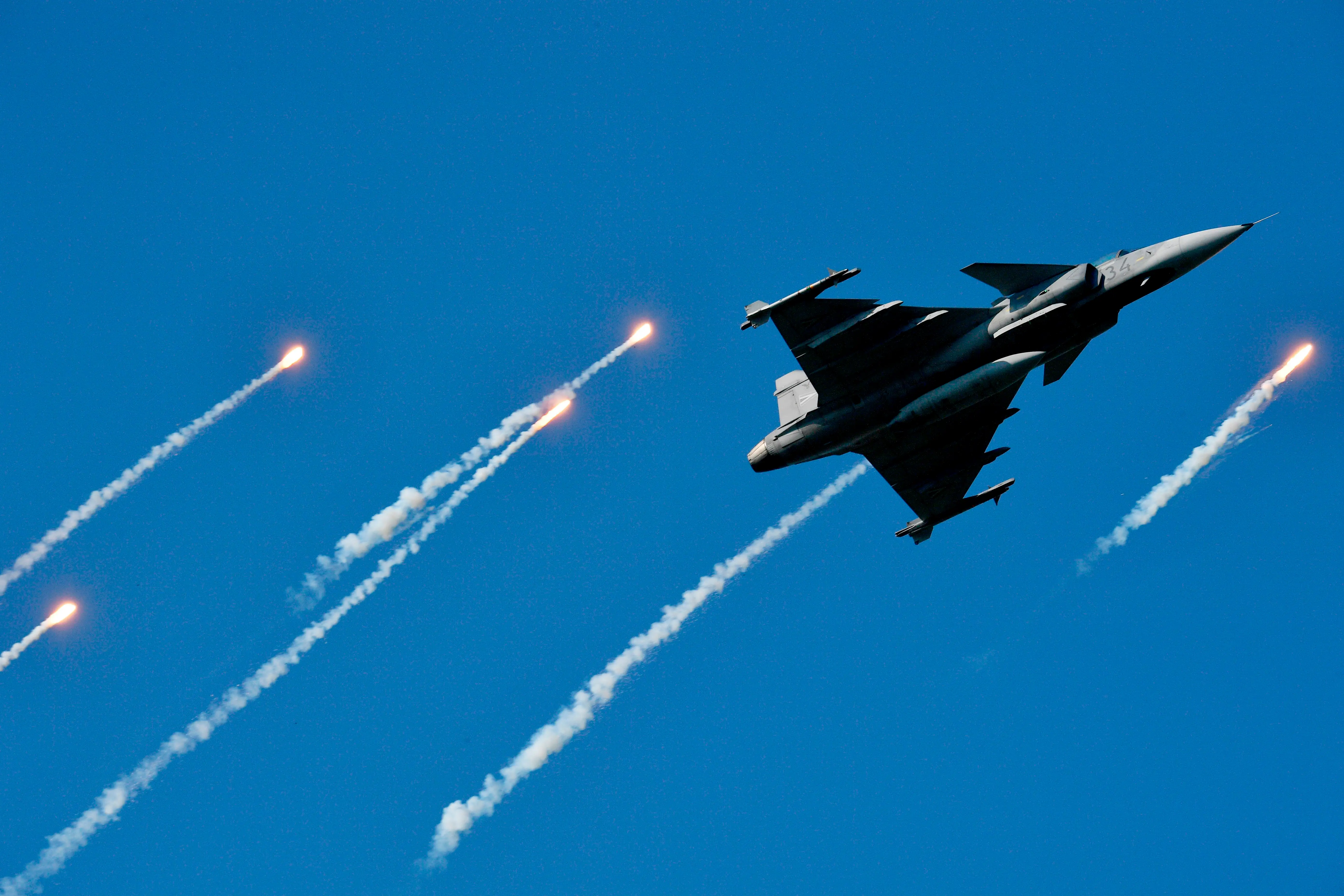 A grey fighter jet in a blue sky