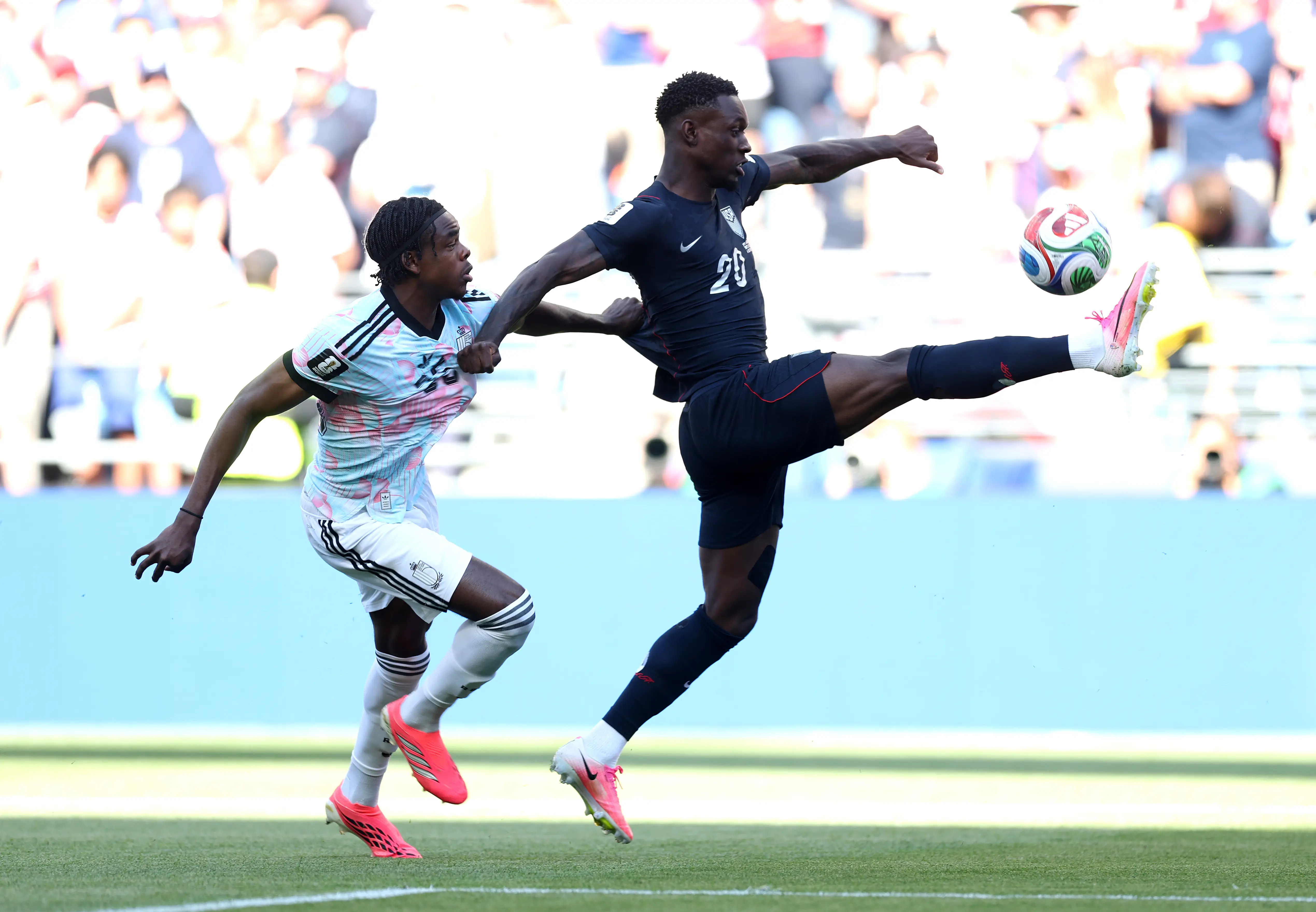 Folarin Balogun #20 of the United States controls the ball against Nathan Ngoy #25 of Belgium during the FIFA World Cup 2026 Round of 16 match between USA and Belgium at Seattle Stadium on July 06, 2026 in Seattle, Washington.