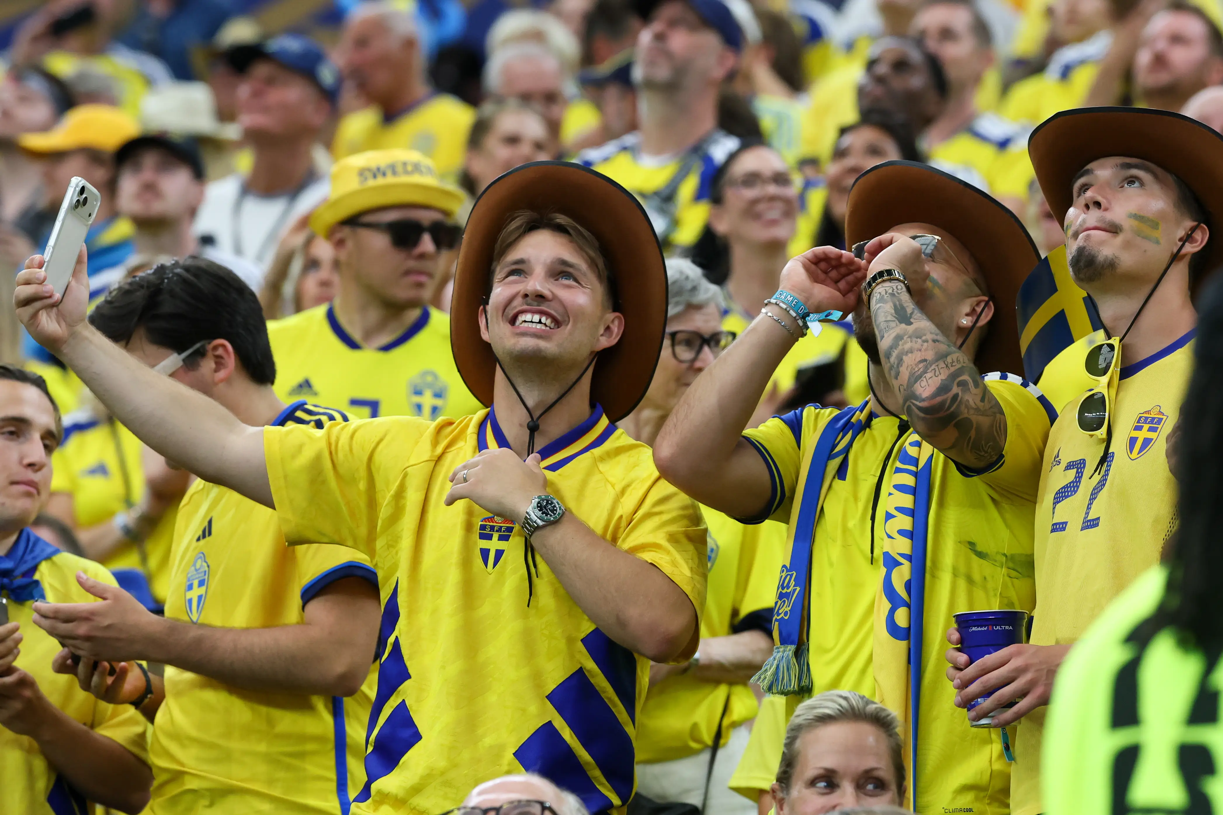 A group of Sweden fans cheer while wearing cowboy hats ahead of the FIFA World Cup 2026 Group F match between Japan and Sweden on June 25, 2026, at Dallas Stadium in Dallas, Texas. (
