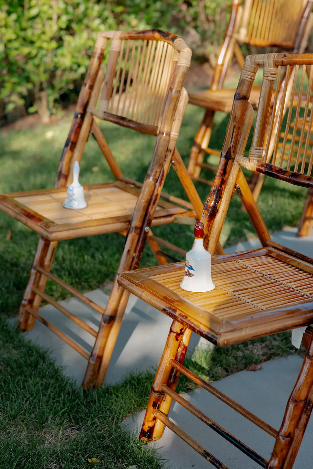 Wooden chairs with bells on them.