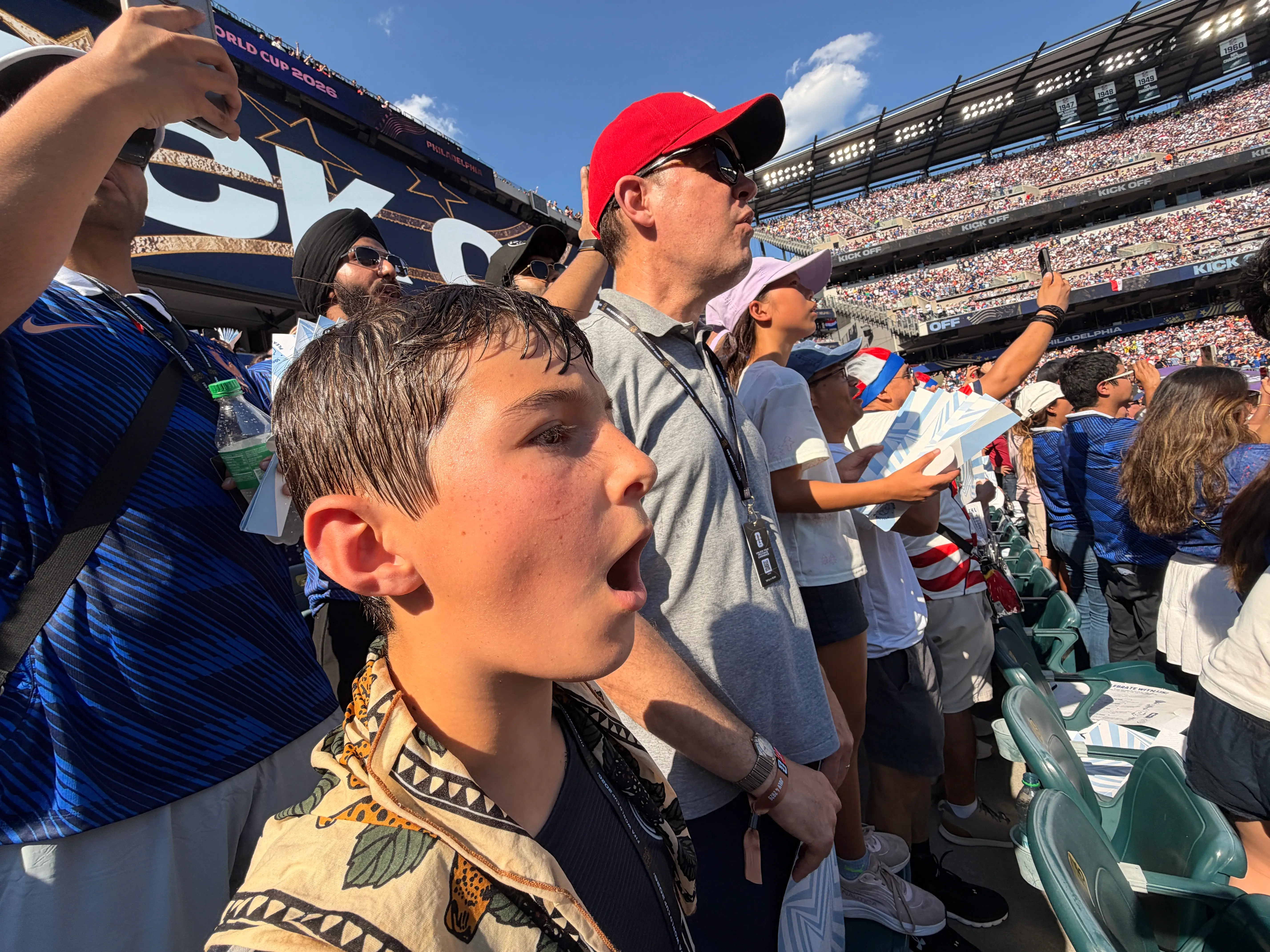 The author's son and husband cheer during a World Cup match in 2026.