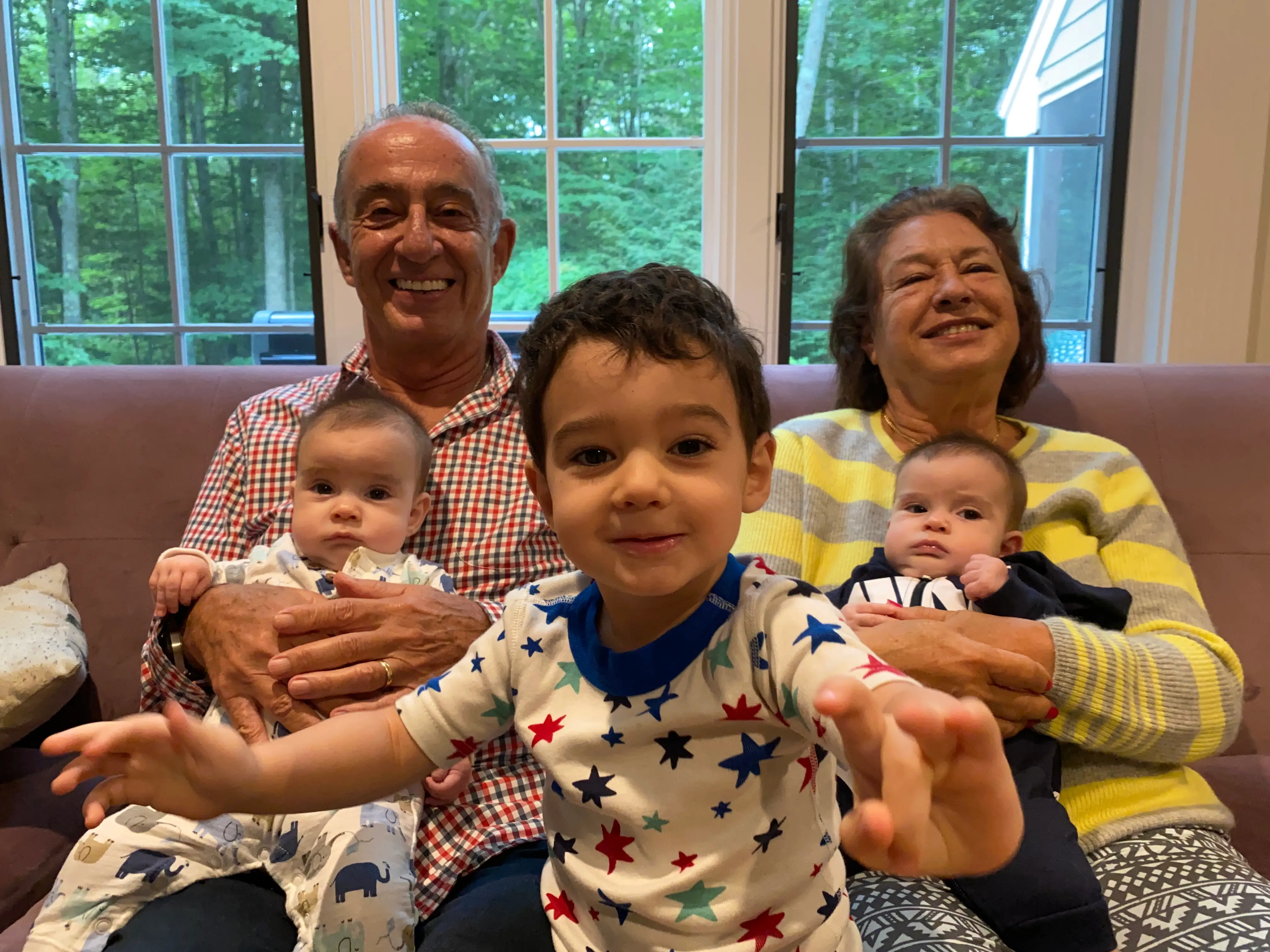 Grandparents holding kids