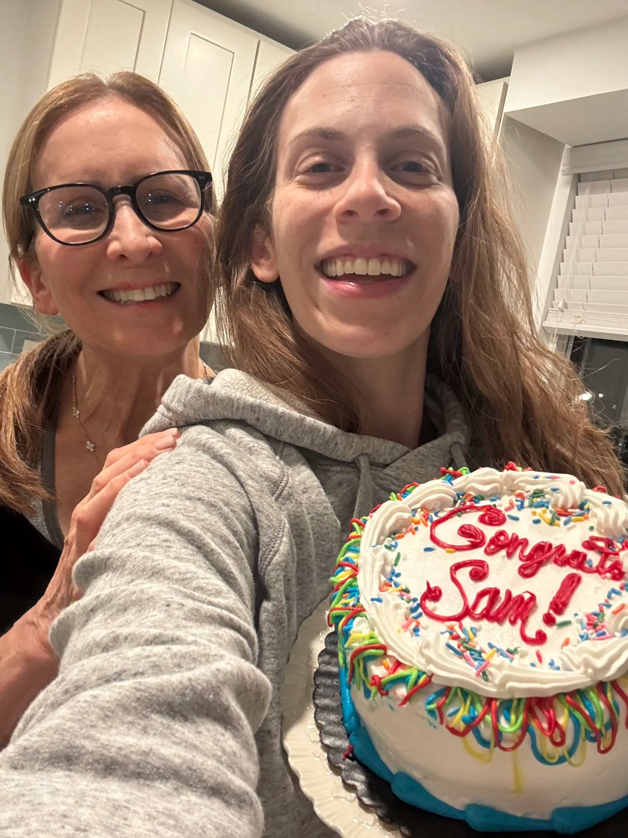 the author with her mom and a cake that says 