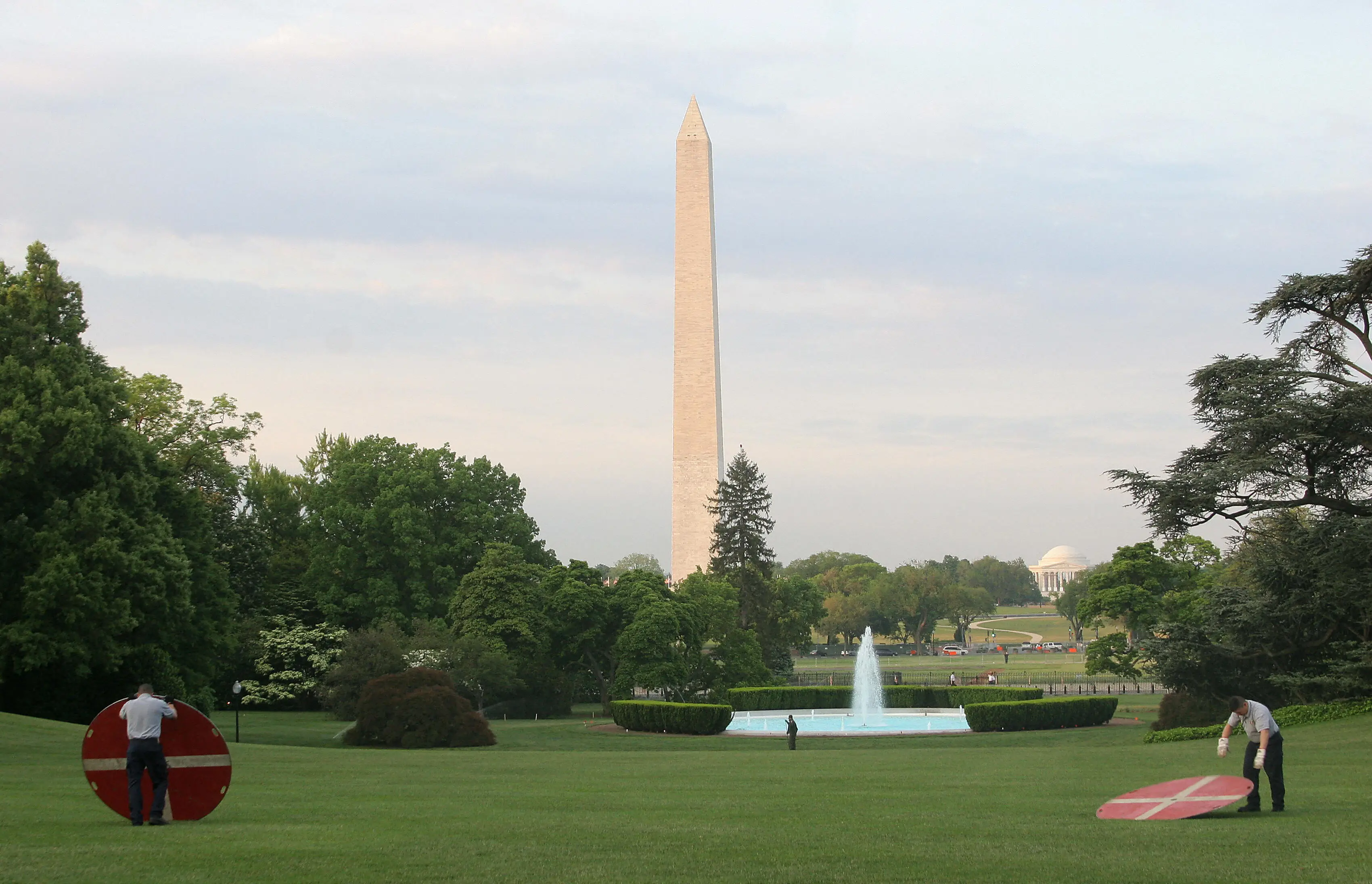 Employees place landing pads on the White House South Lawn
