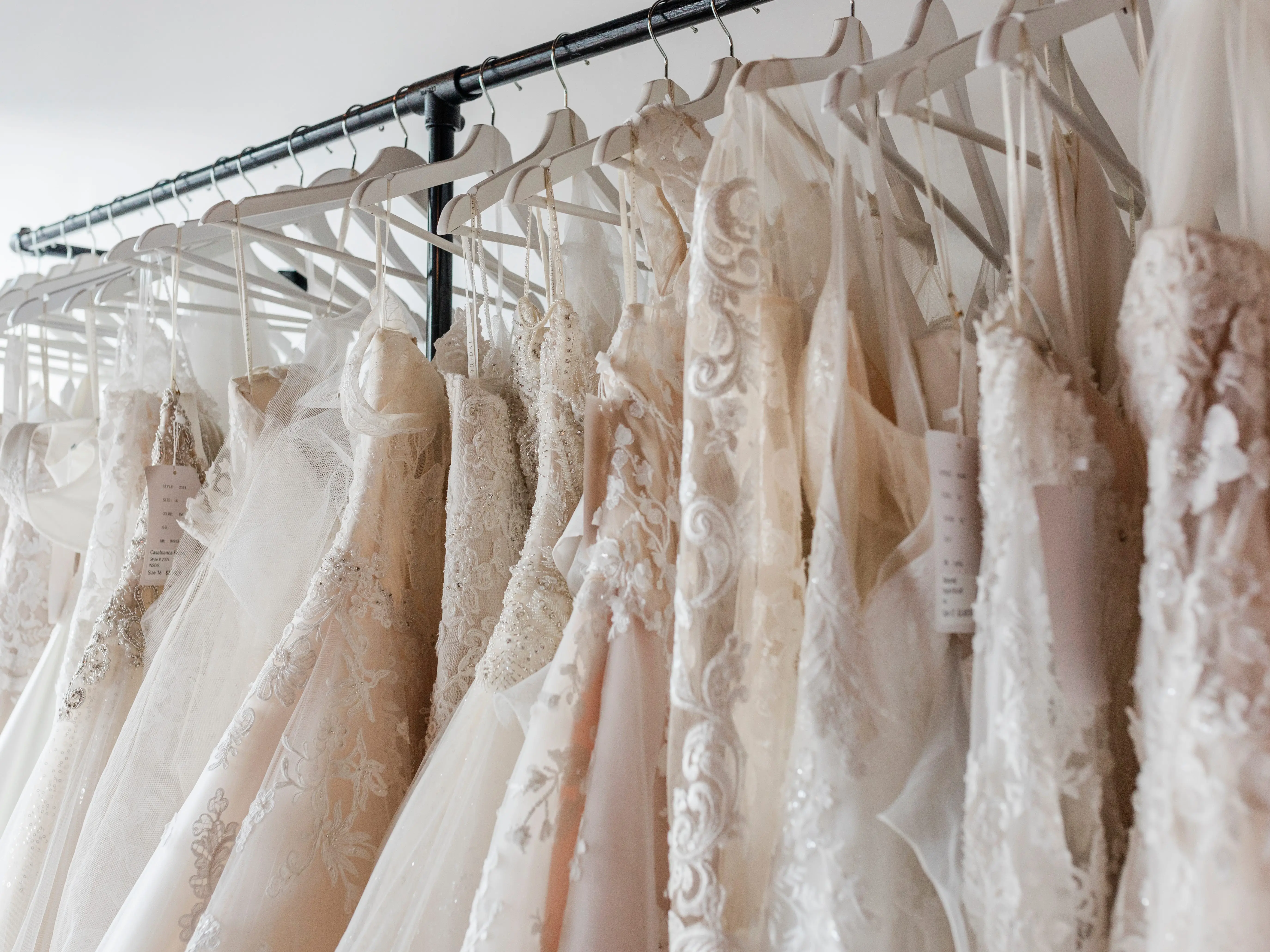 Various wedding dresses on a rack.