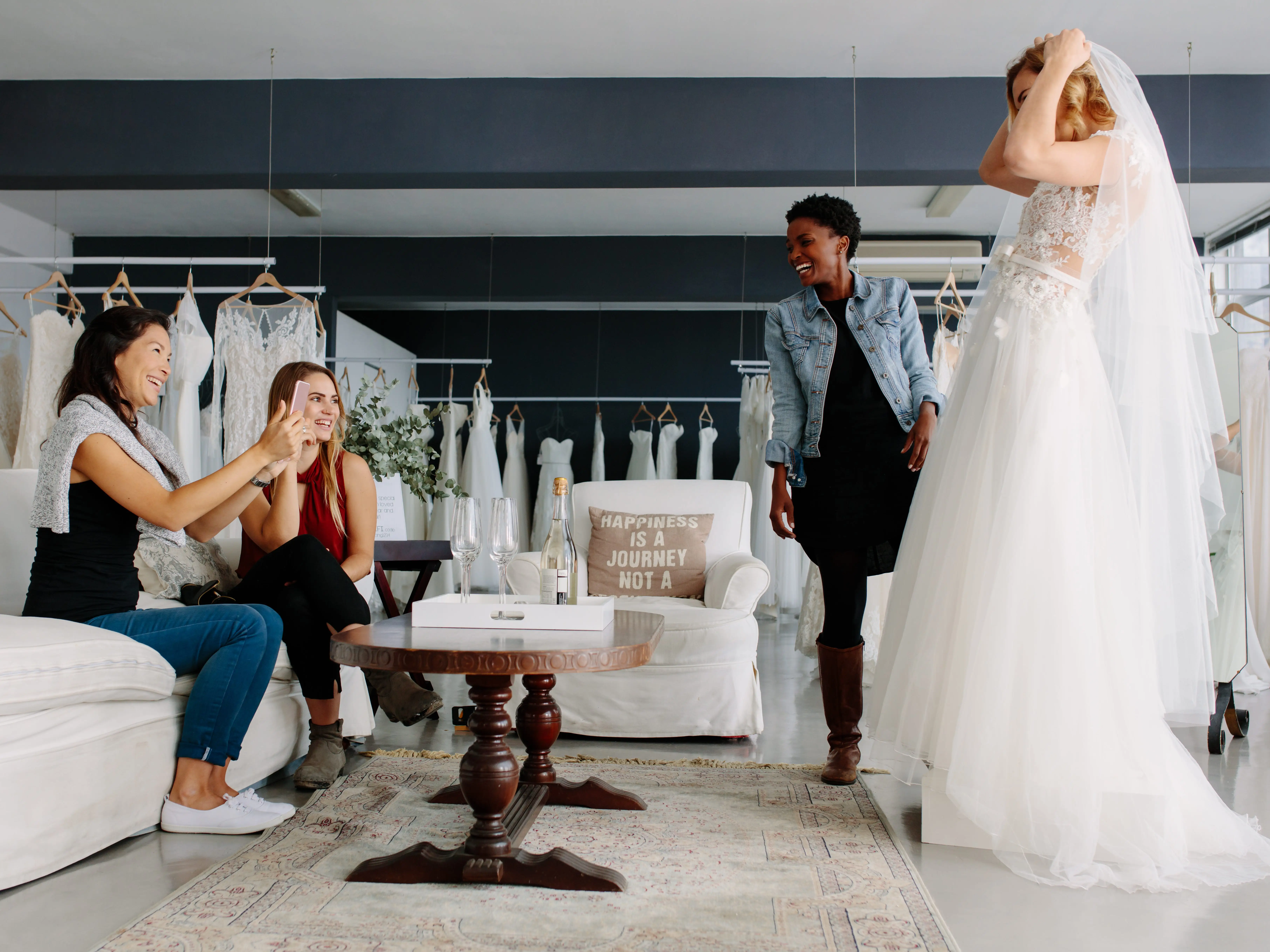 A bride trying on a dress with friends.