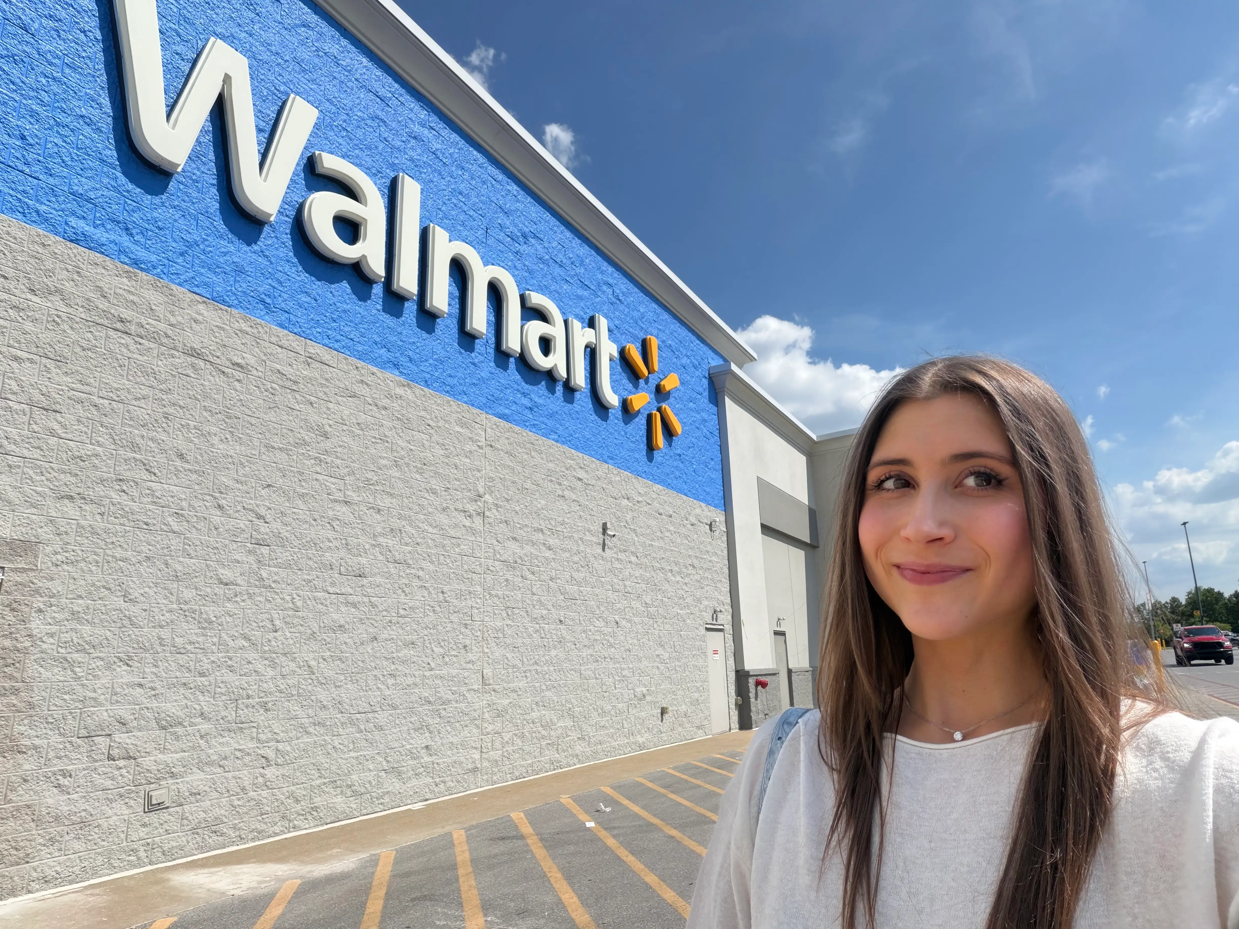 Woman smiling outside of Walmart