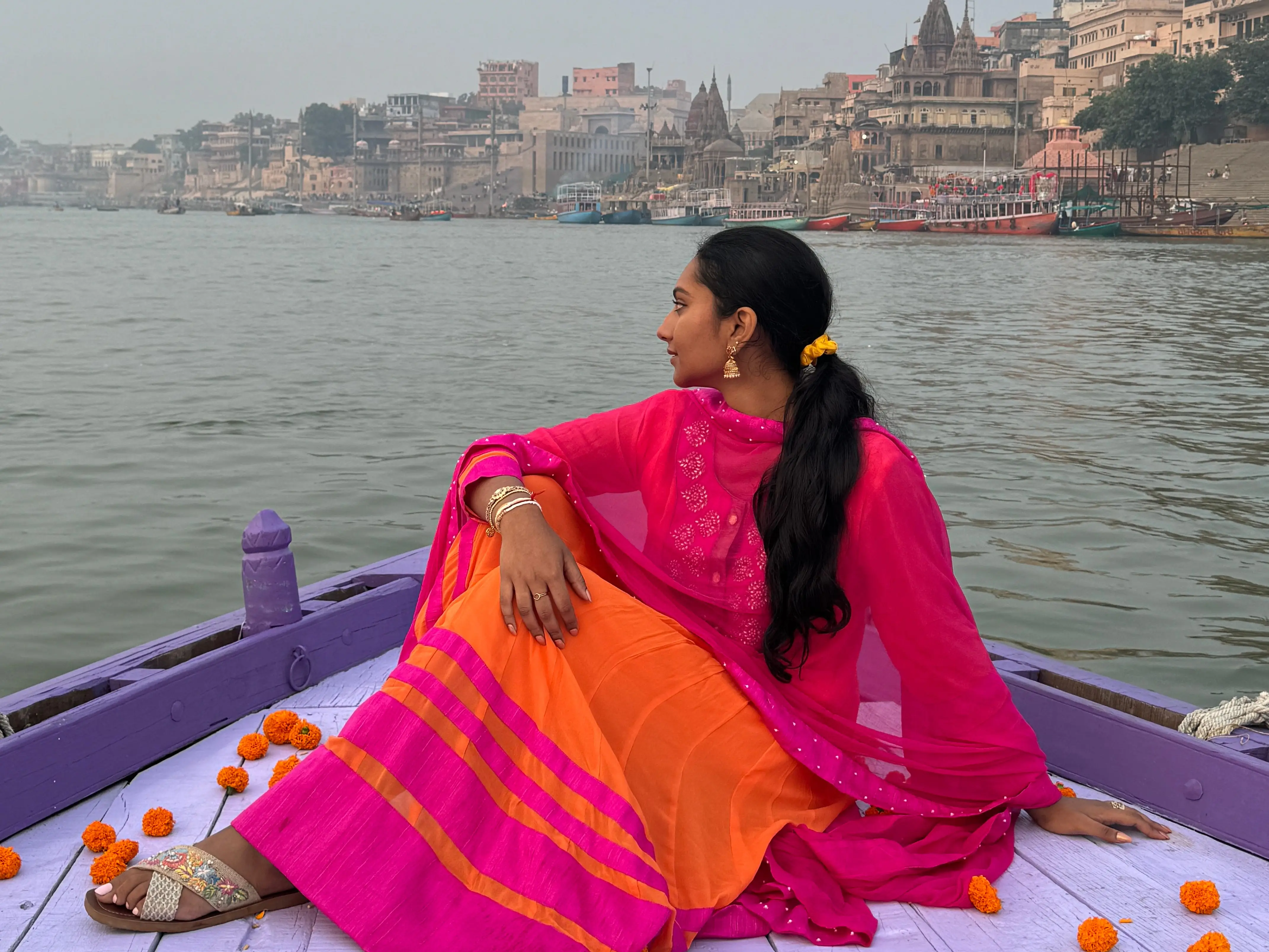 The writer sitting on a boat in Varanasi, India.