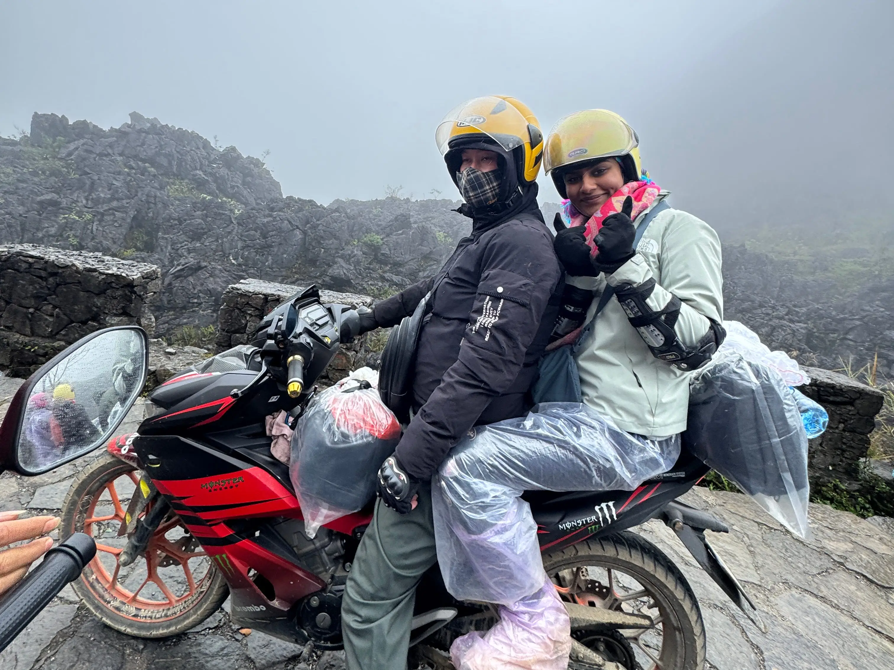 The writer (right) riding a motorbike along the Ha Giang Loop in Vietnam.