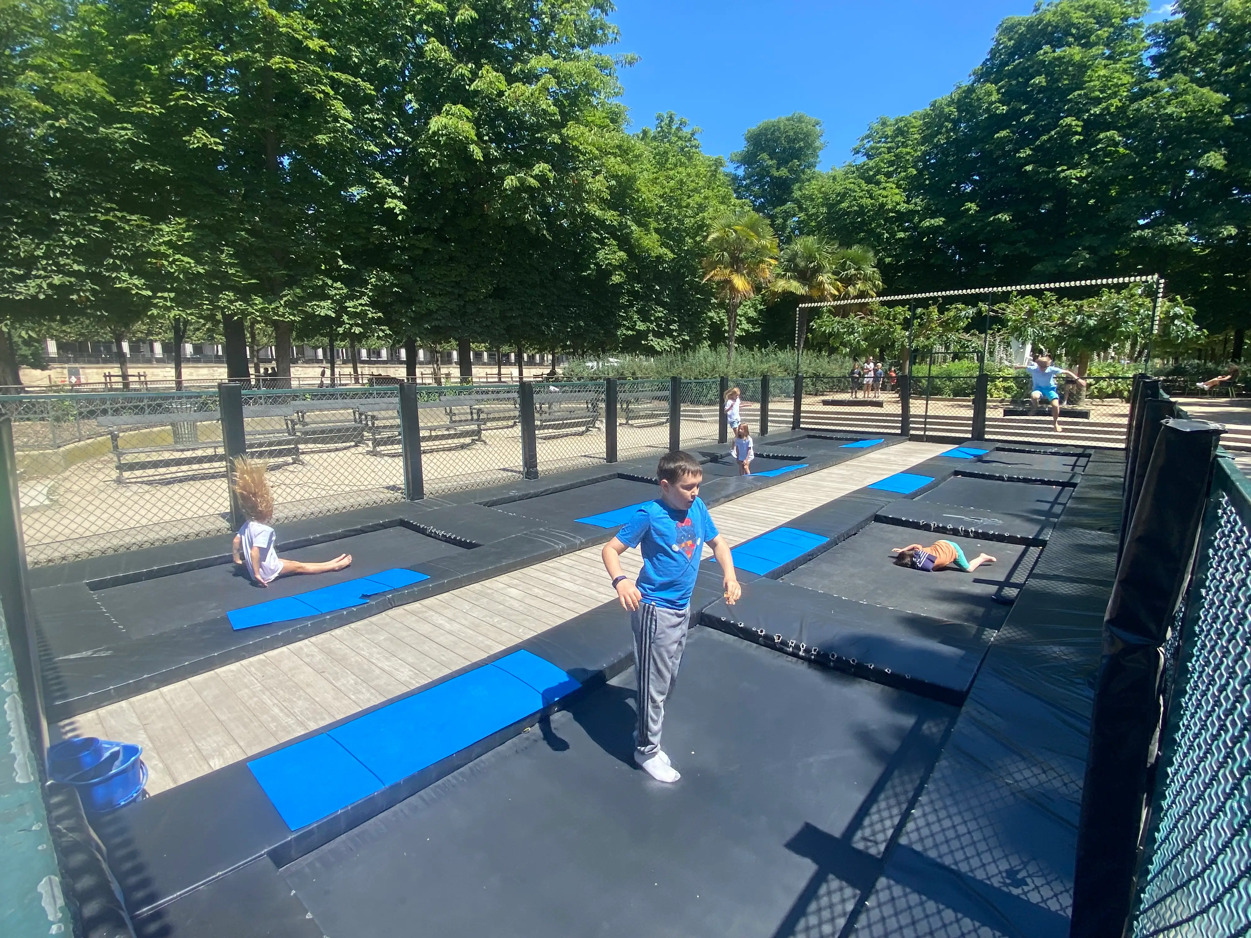 The author's children enjoy jumping on the trampolines at Tuileries Garden.