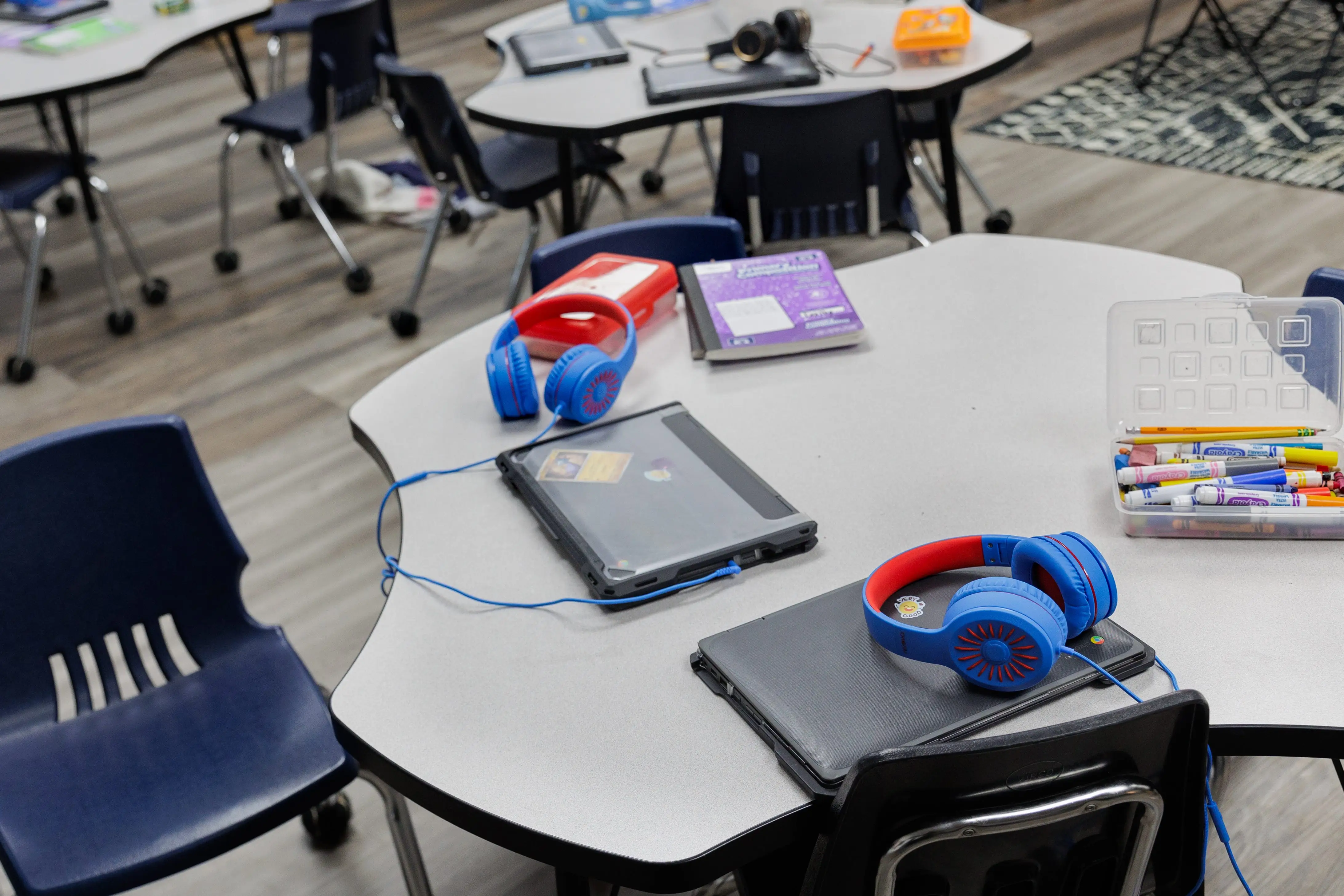 Laptops and headphones in a classroom at the Woodson Independent School District location in Woodson, Texas.