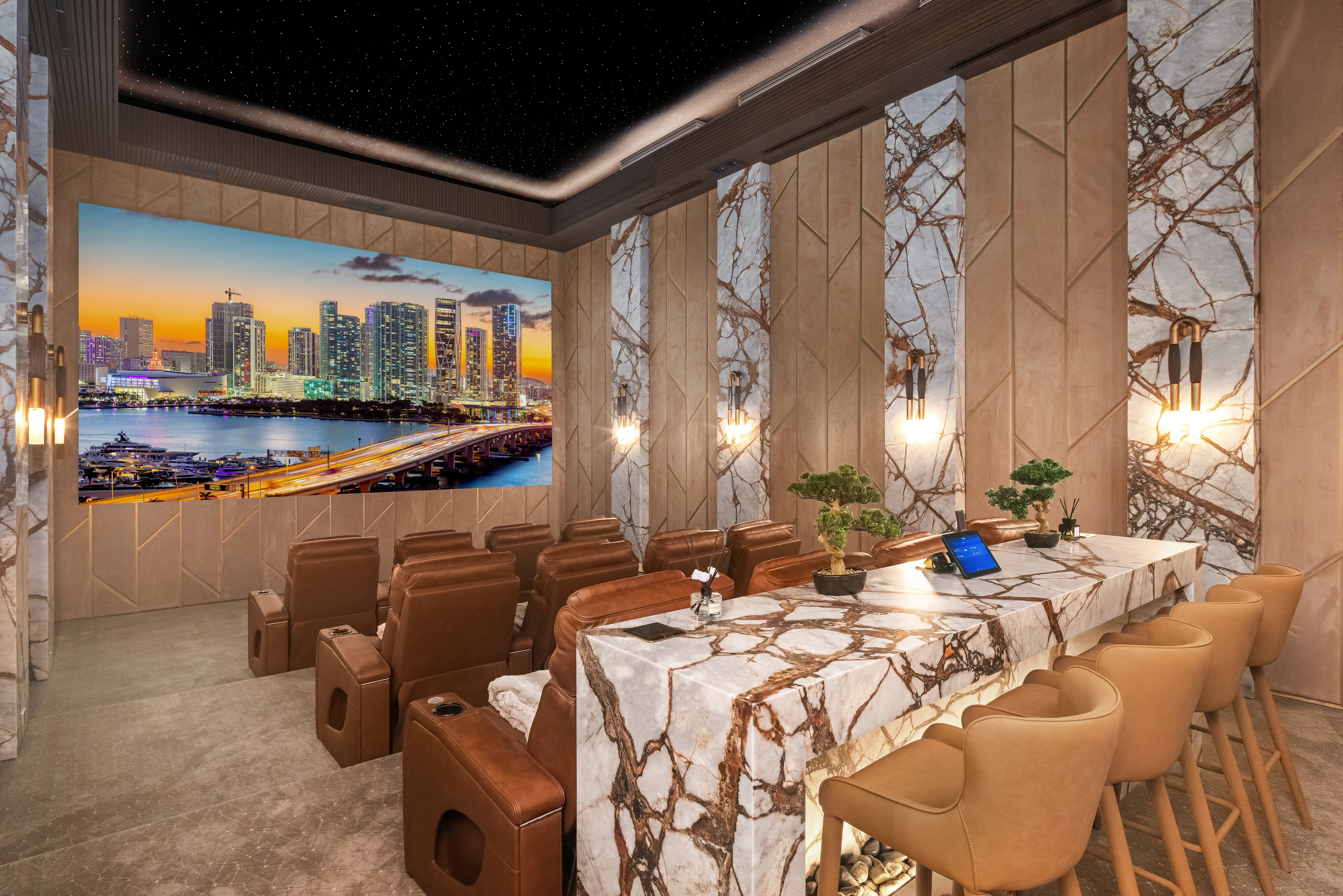 Luxury conference and screening room with marble surfaces, leather seats, and a large display showing a waterfront skyline.