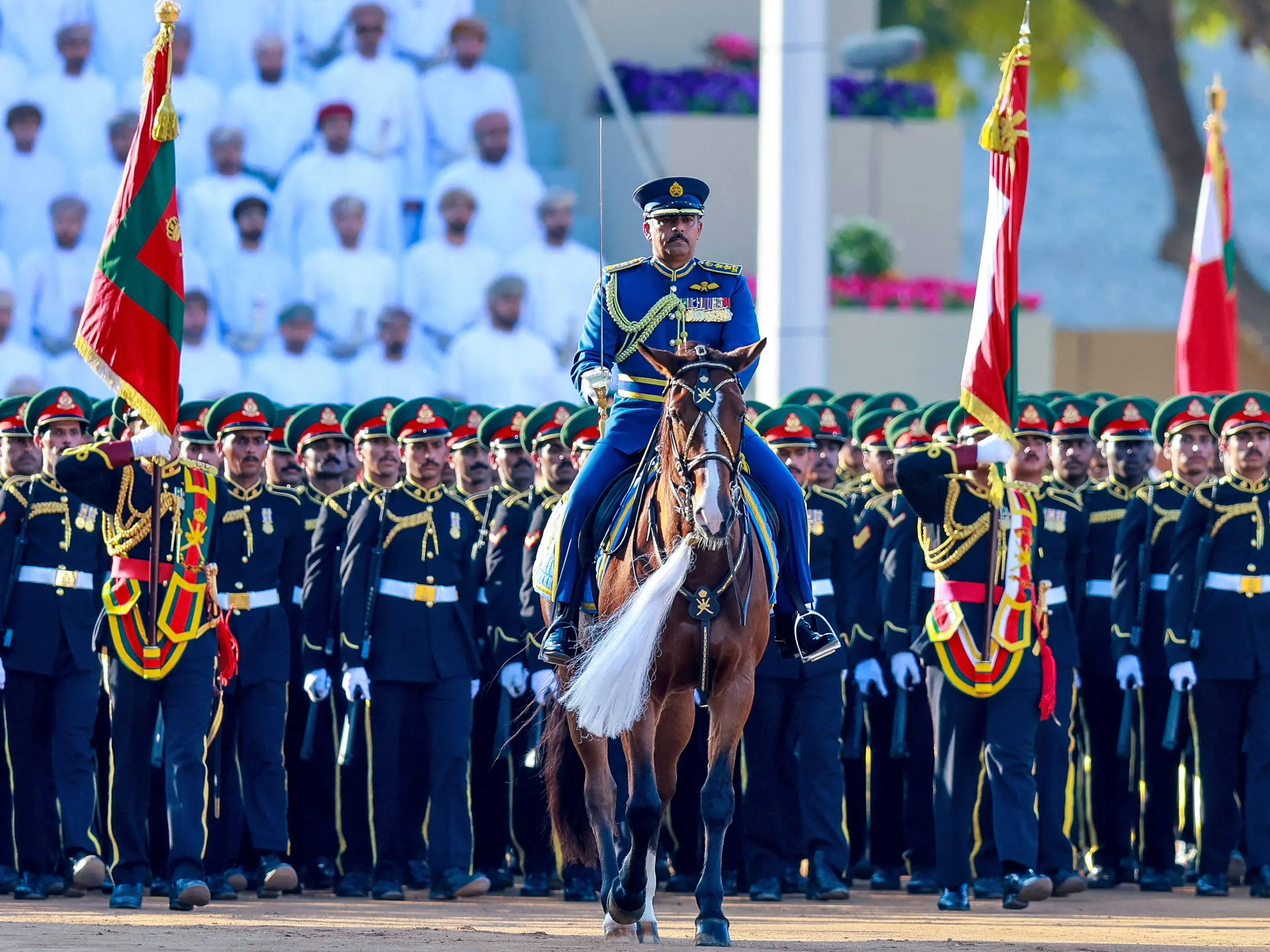 Omani soldiers stand at attention during a military parade marking the Sultanate's official celebrations for their national day at Midan al-Fath Stadium in Muscat on November 20, 2025.