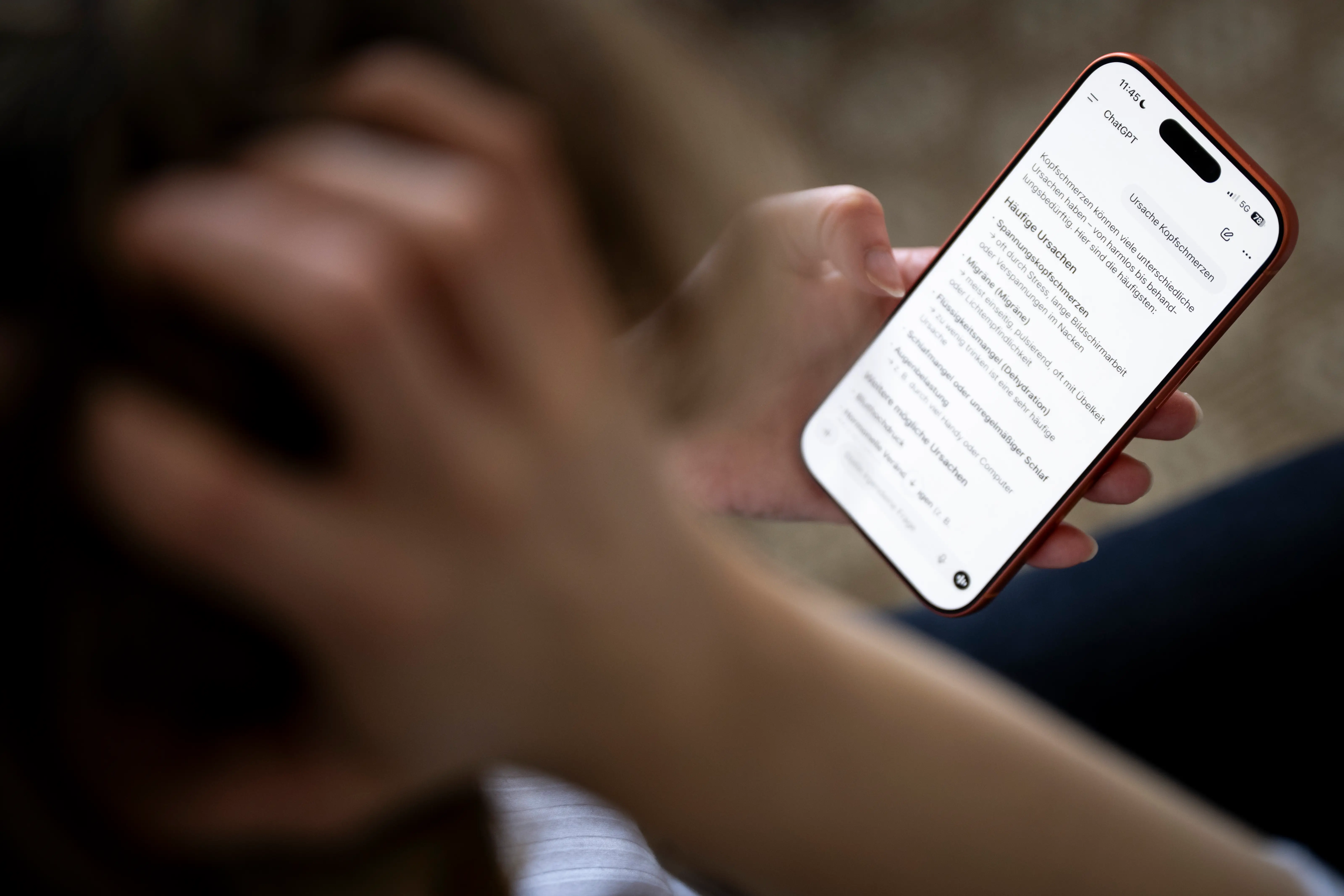 A person use ChatGPT on a smartphone to search for information about the causes of headaches in March 2026