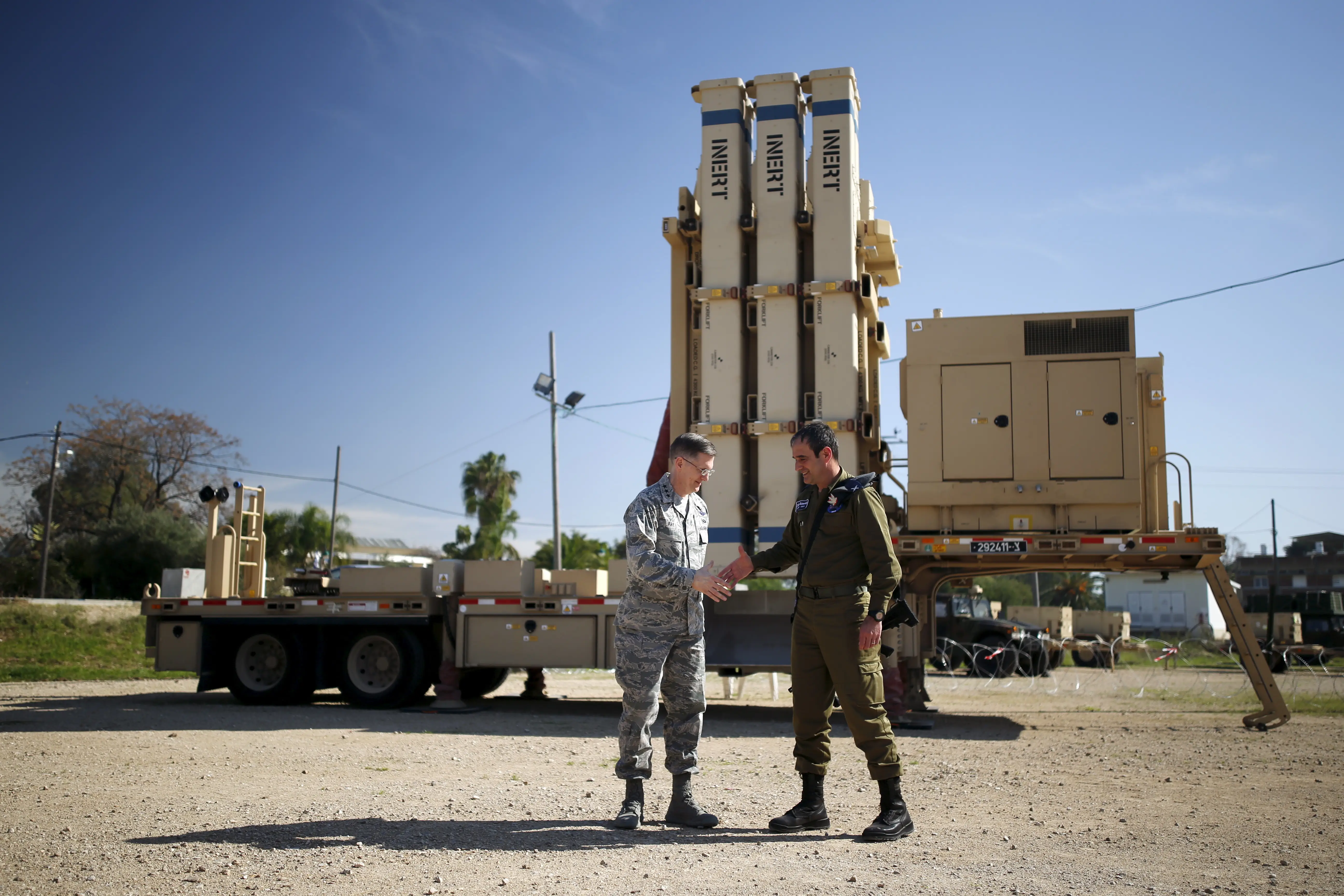 Israeli and US generals shake hands in front of David's Sling.